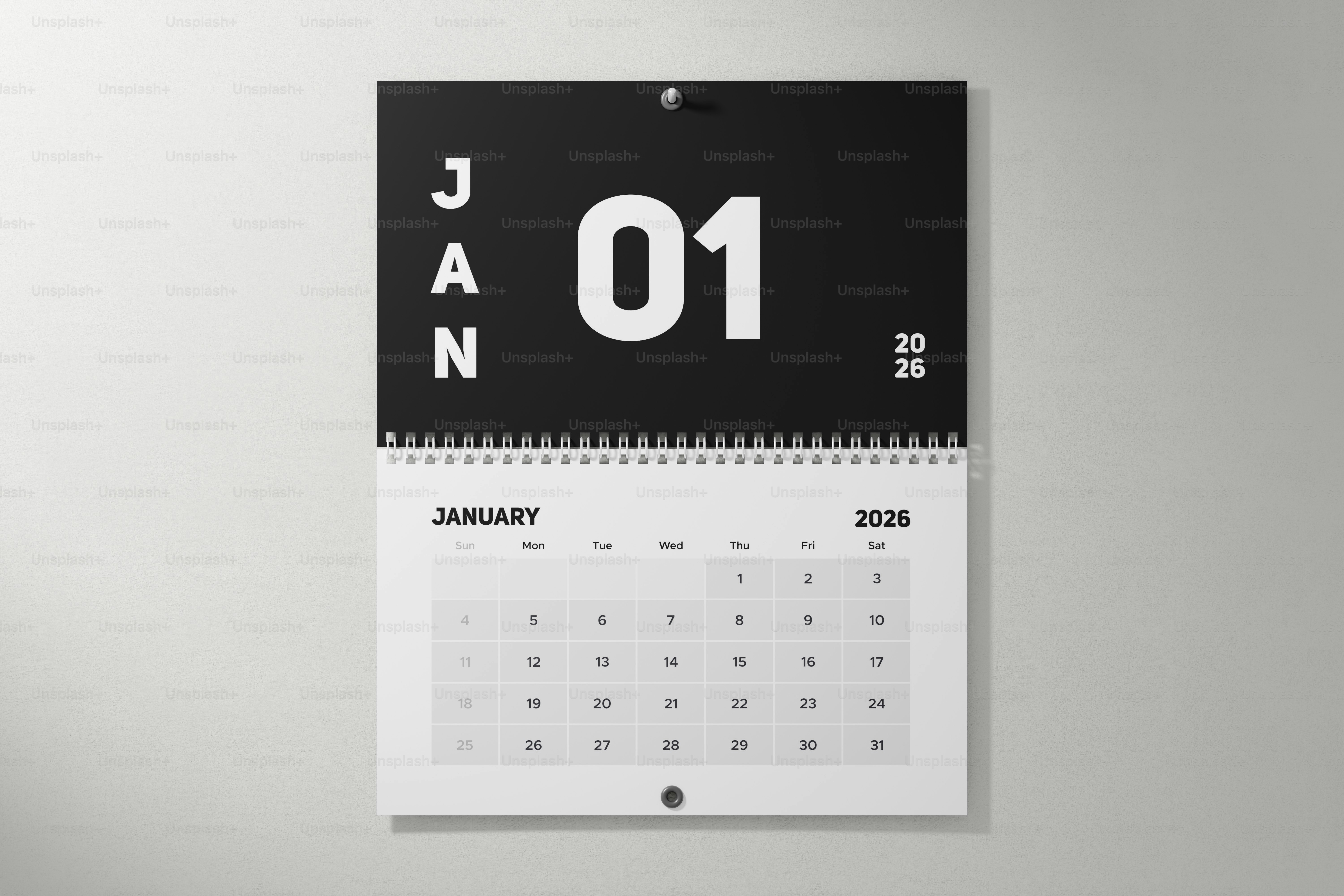 A january 2026 wall calendar hangs on a white wall.