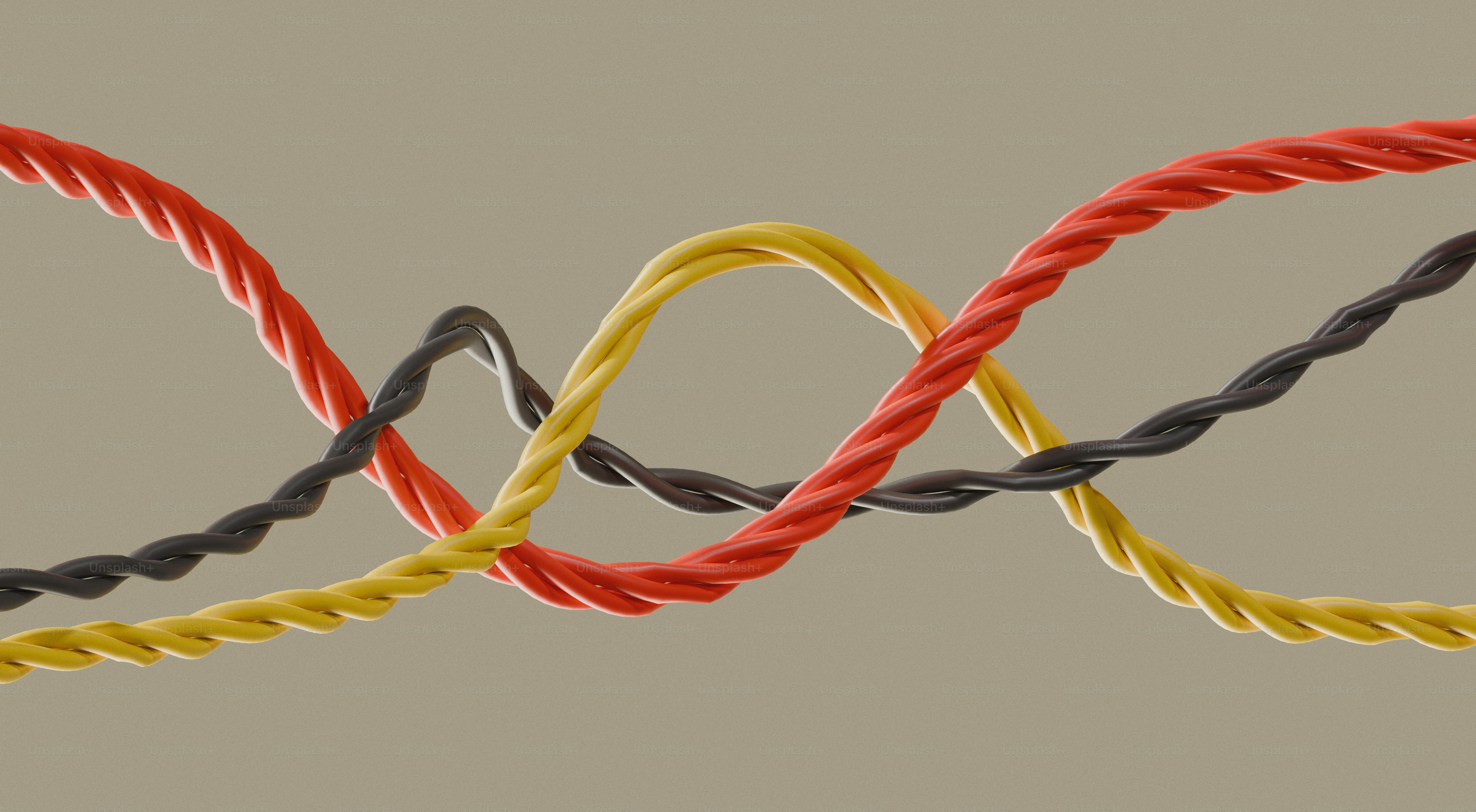 Três fios torcidos coloridos entrelaçados em um fundo liso.