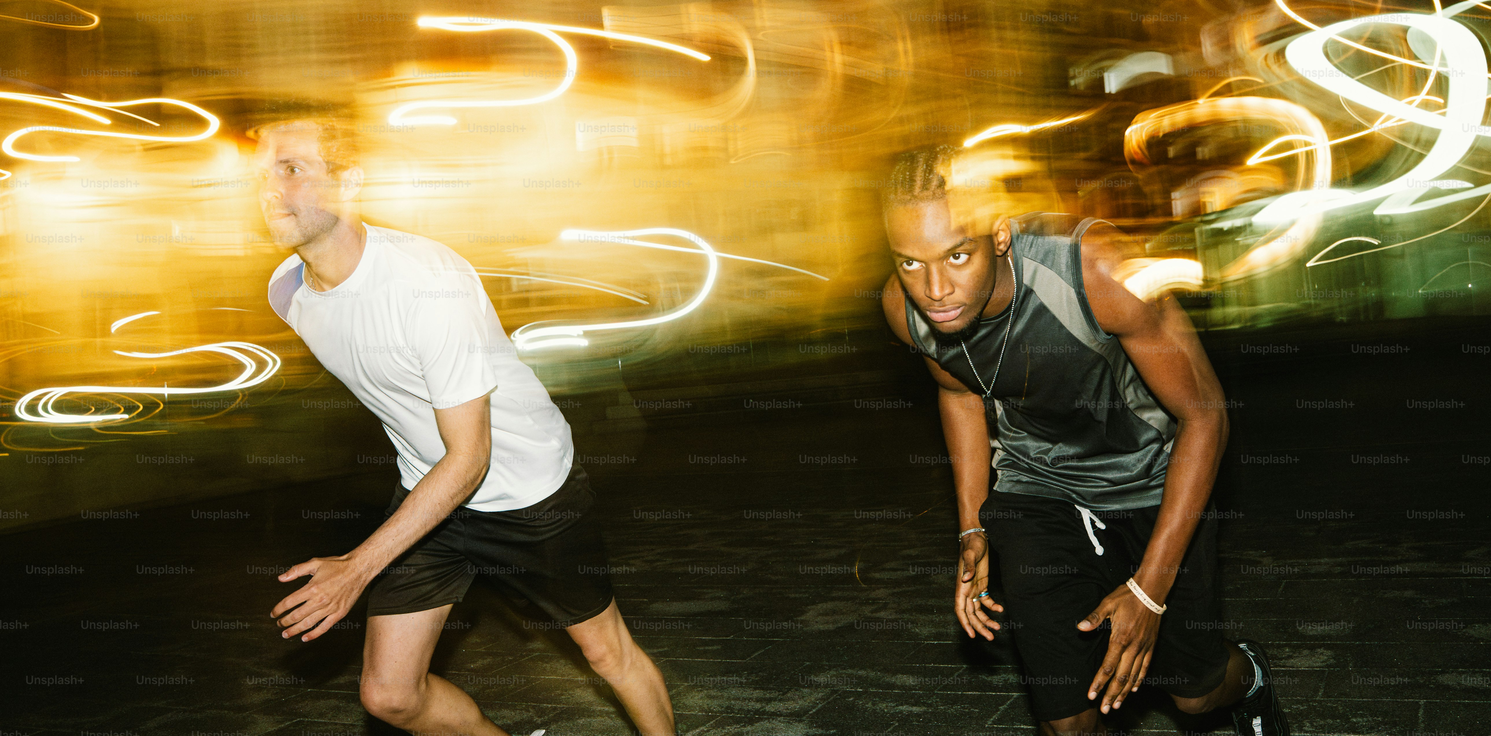 Two men running at night with light streaks photo – Night Image on Unsplash