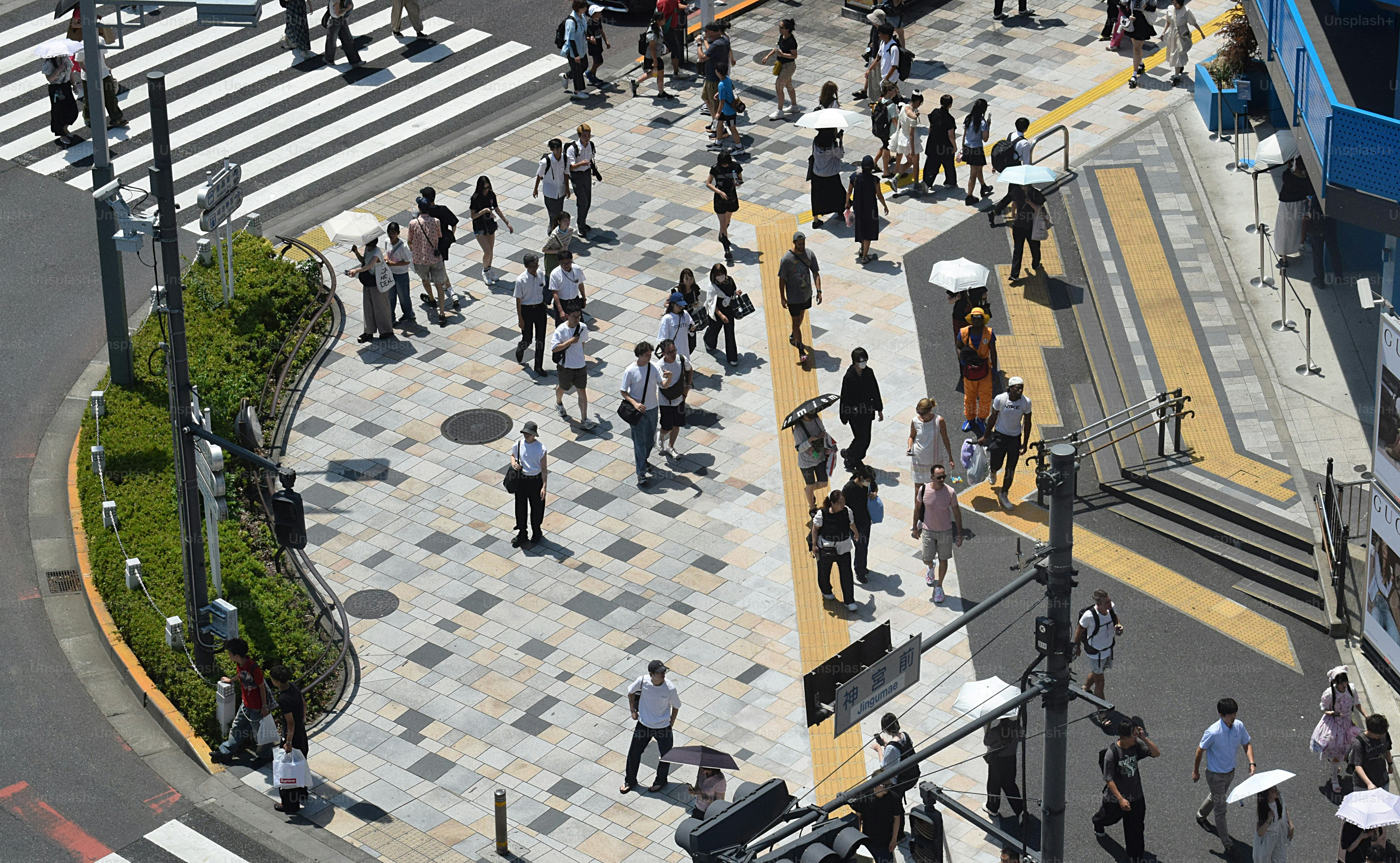 Crowd of people crossing a busy street intersection.