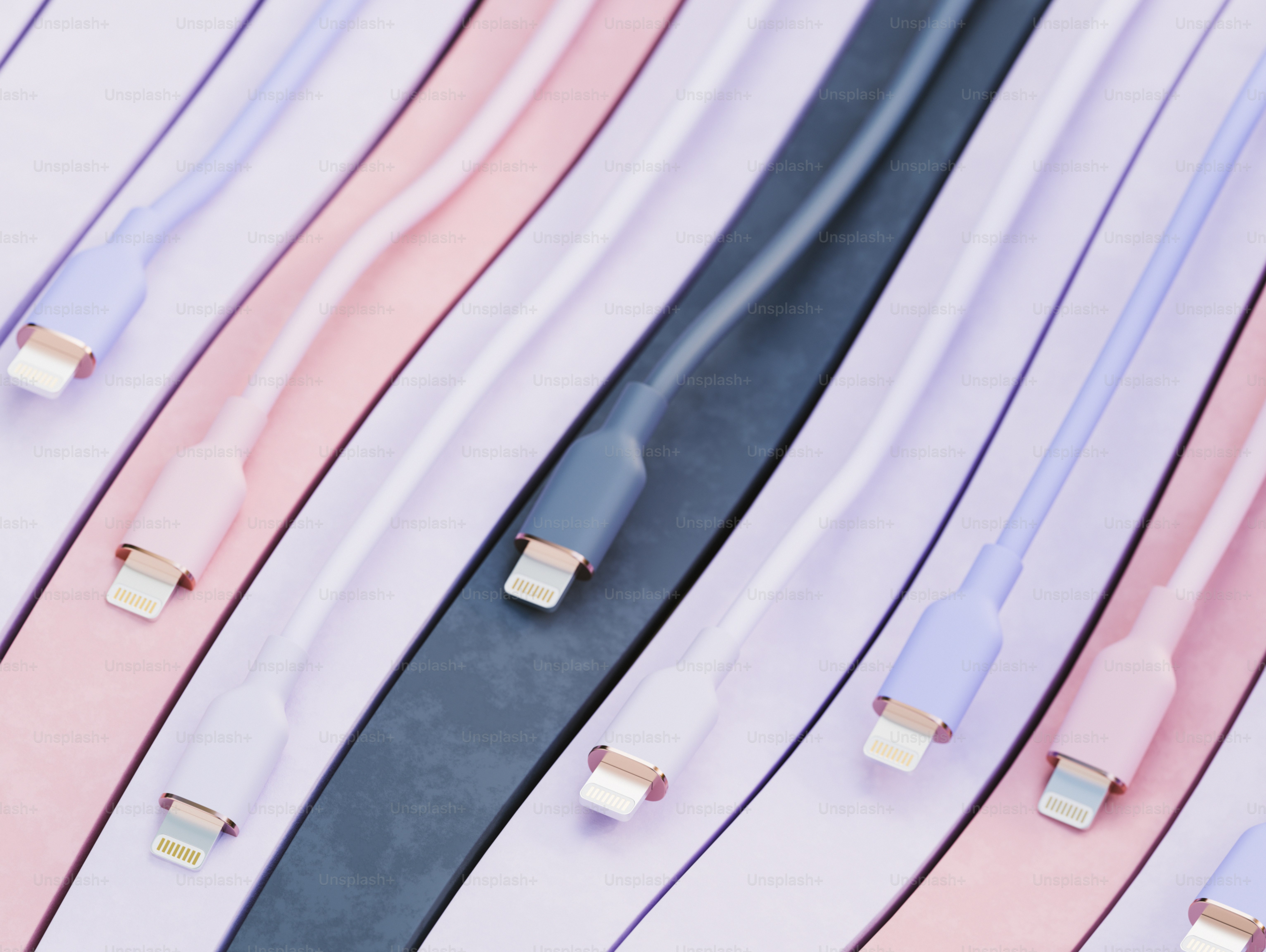 Pastel charging cables arranged diagonally on striped background