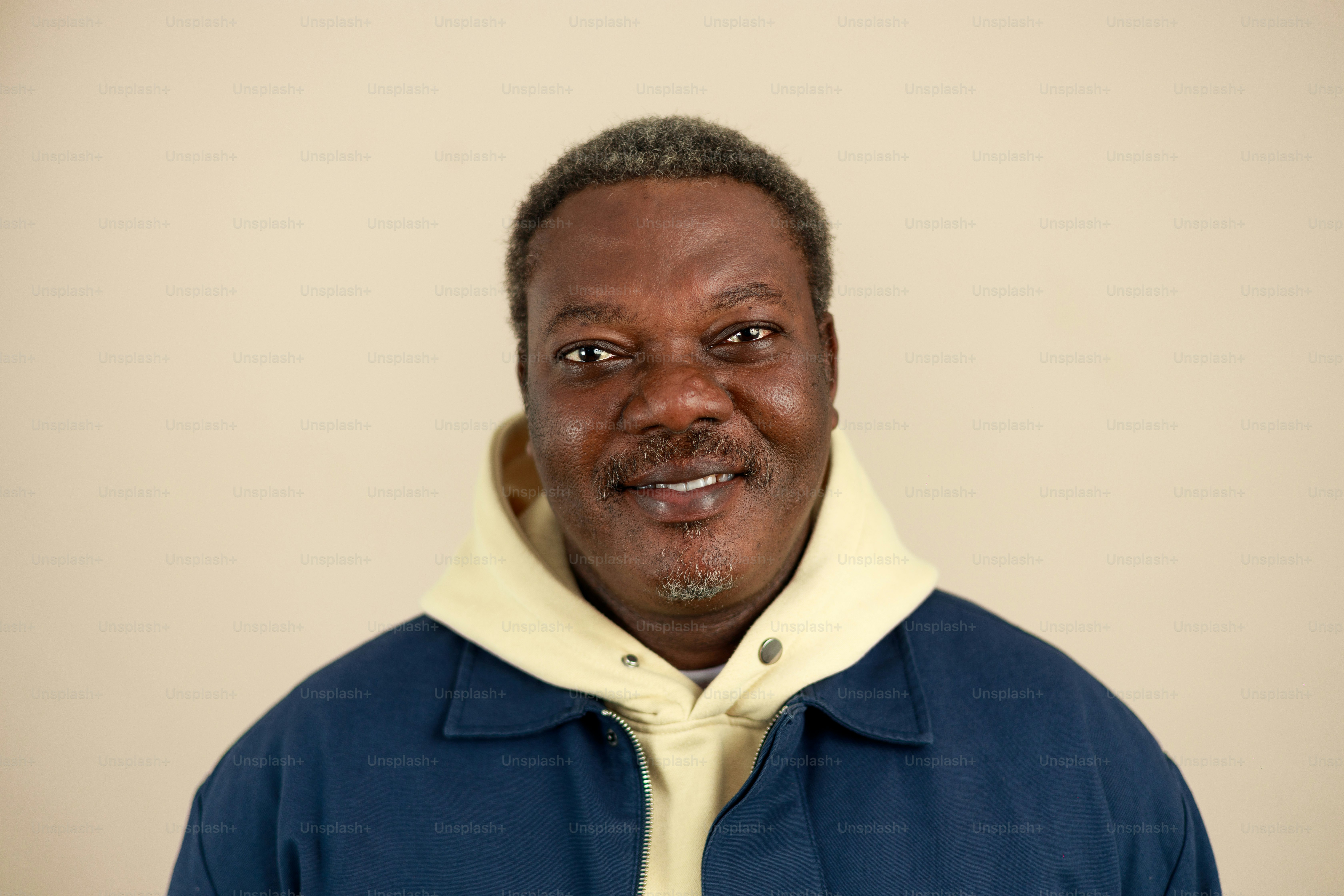 A man with graying hair wearing a blue jacket.