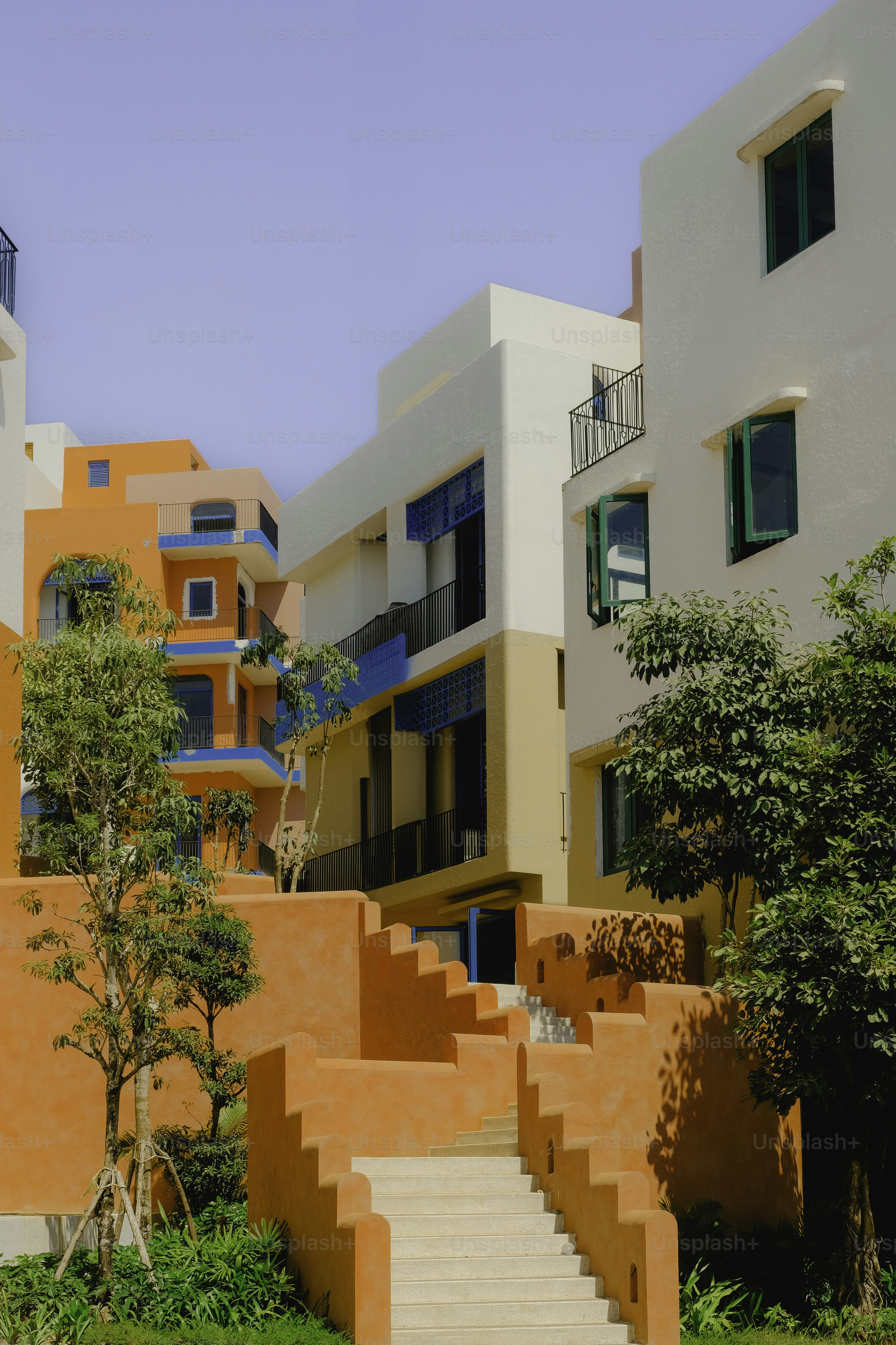 Bunte Gebäude mit orangefarbenen Treppen und grünen Fenstern.