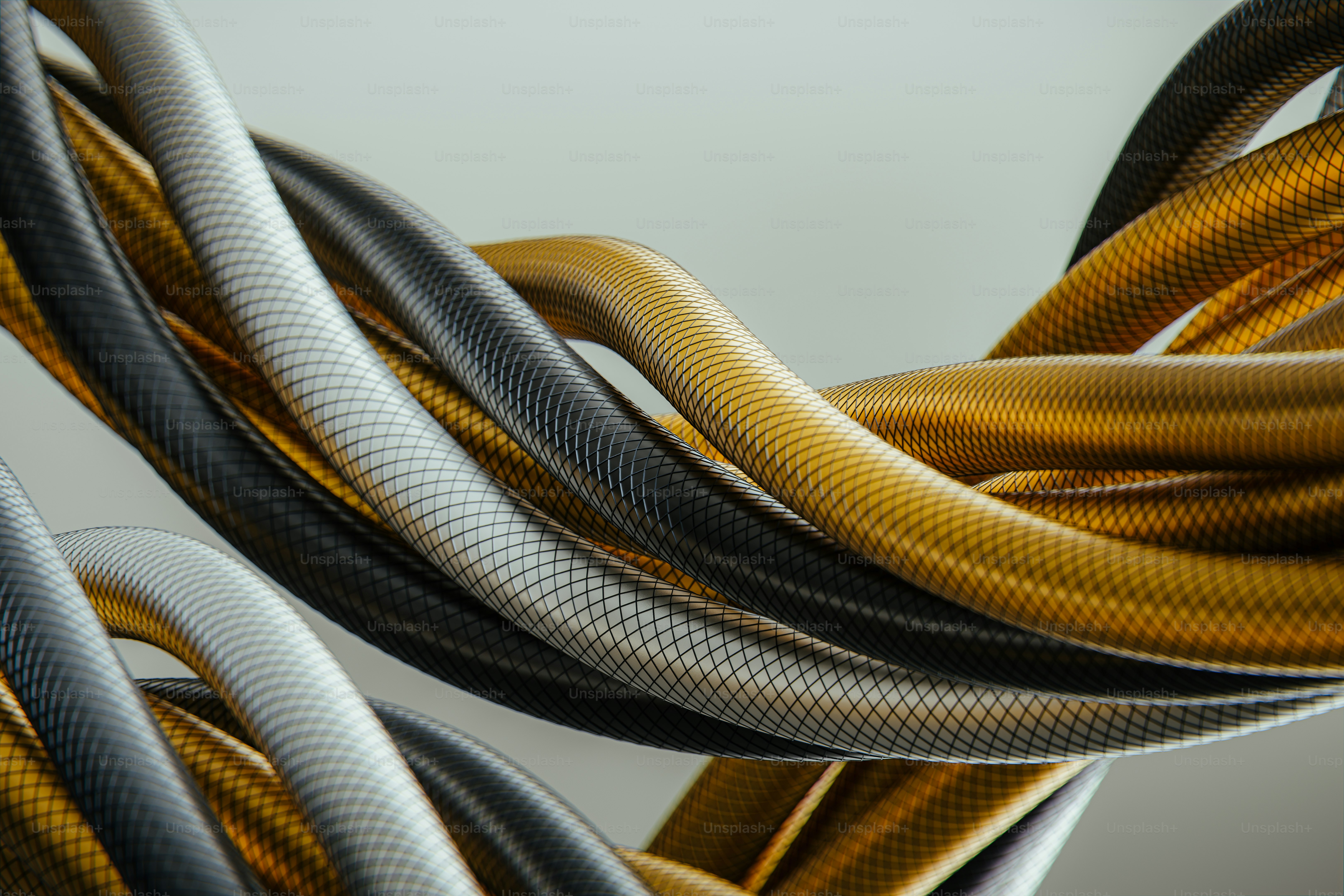 Twisted golden, grey, and white cables on a light background.