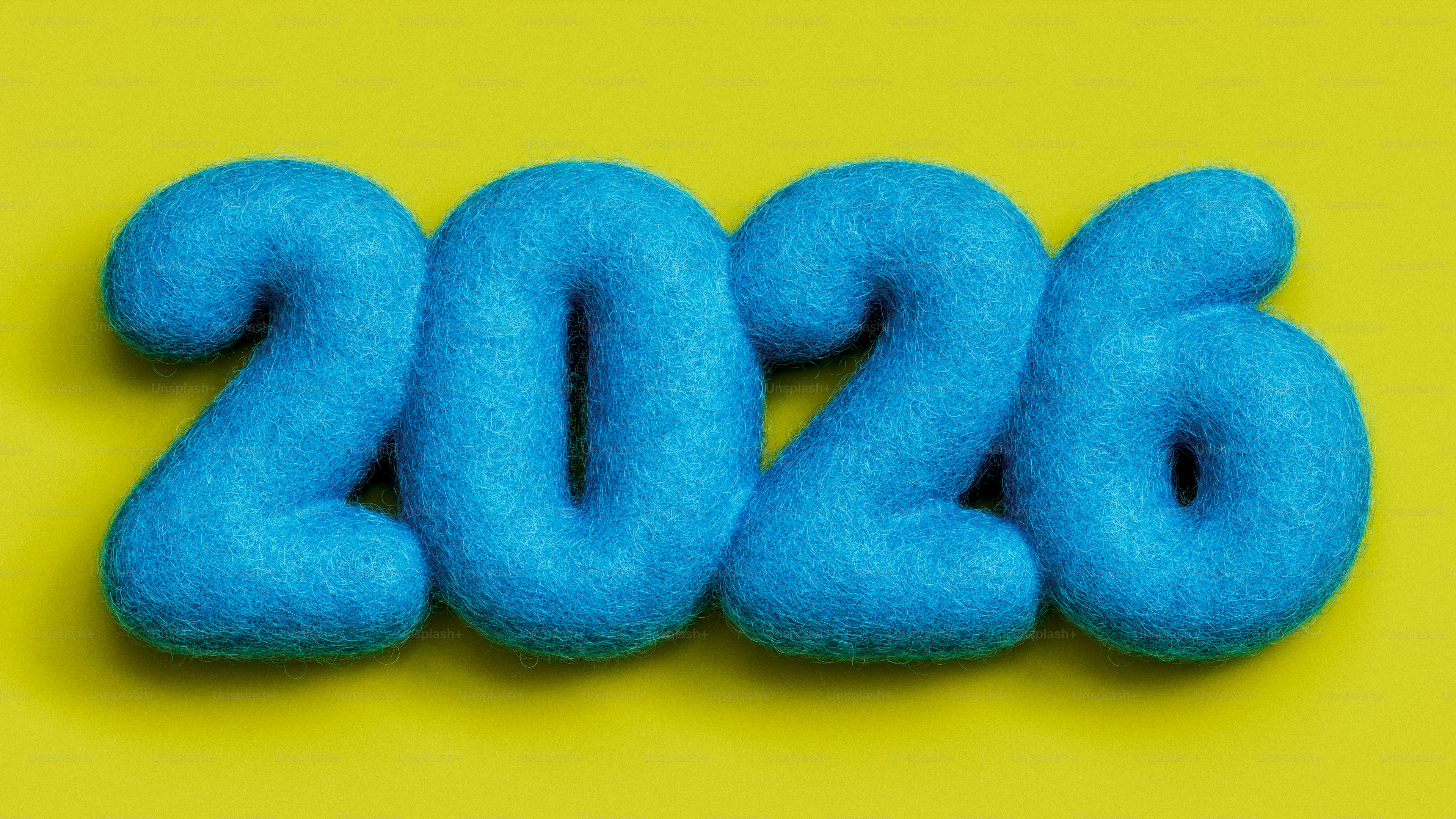 Blue fuzzy numbers spelling out 2026 on yellow