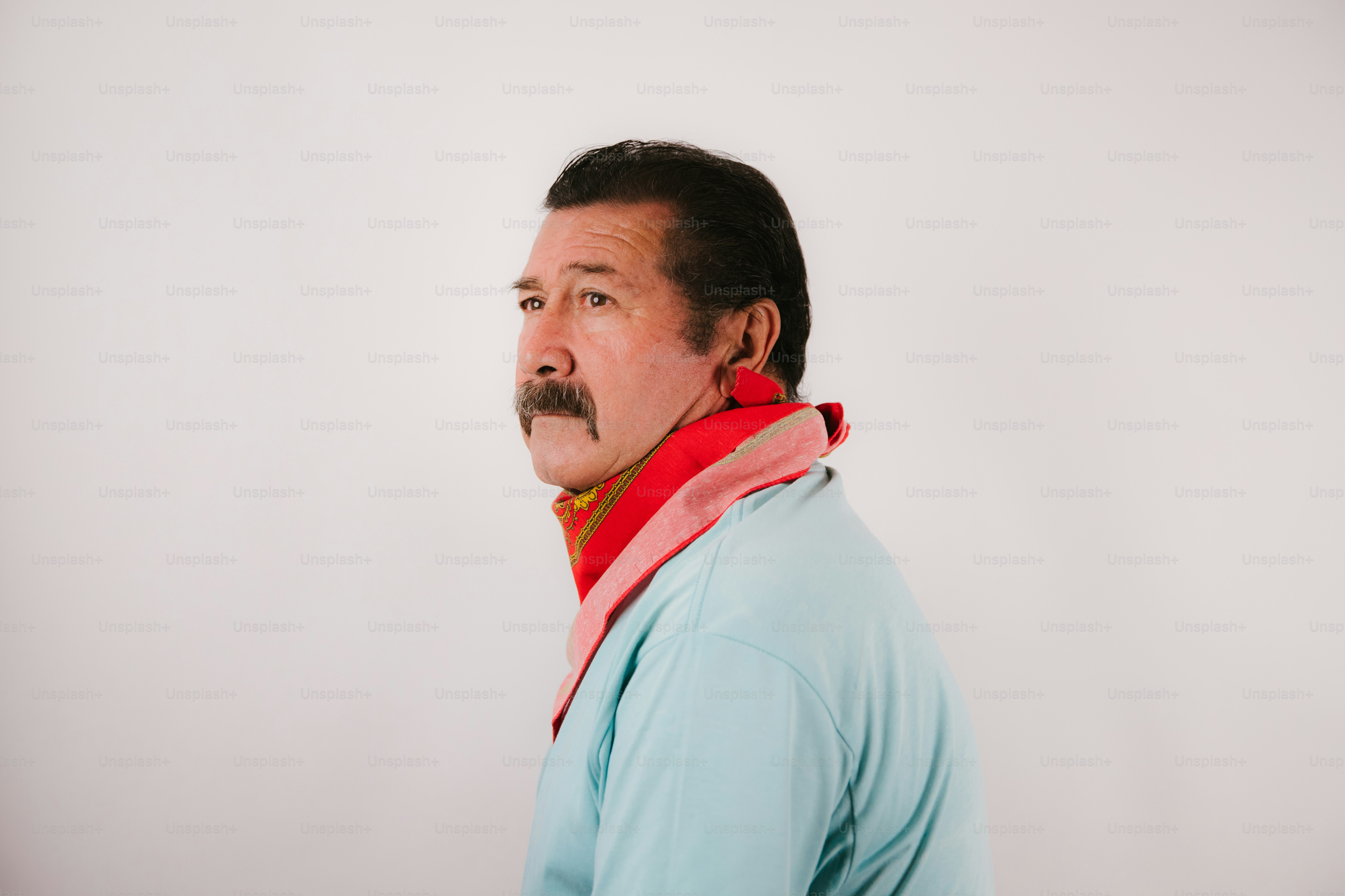Man with mustache wearing colorful scarf