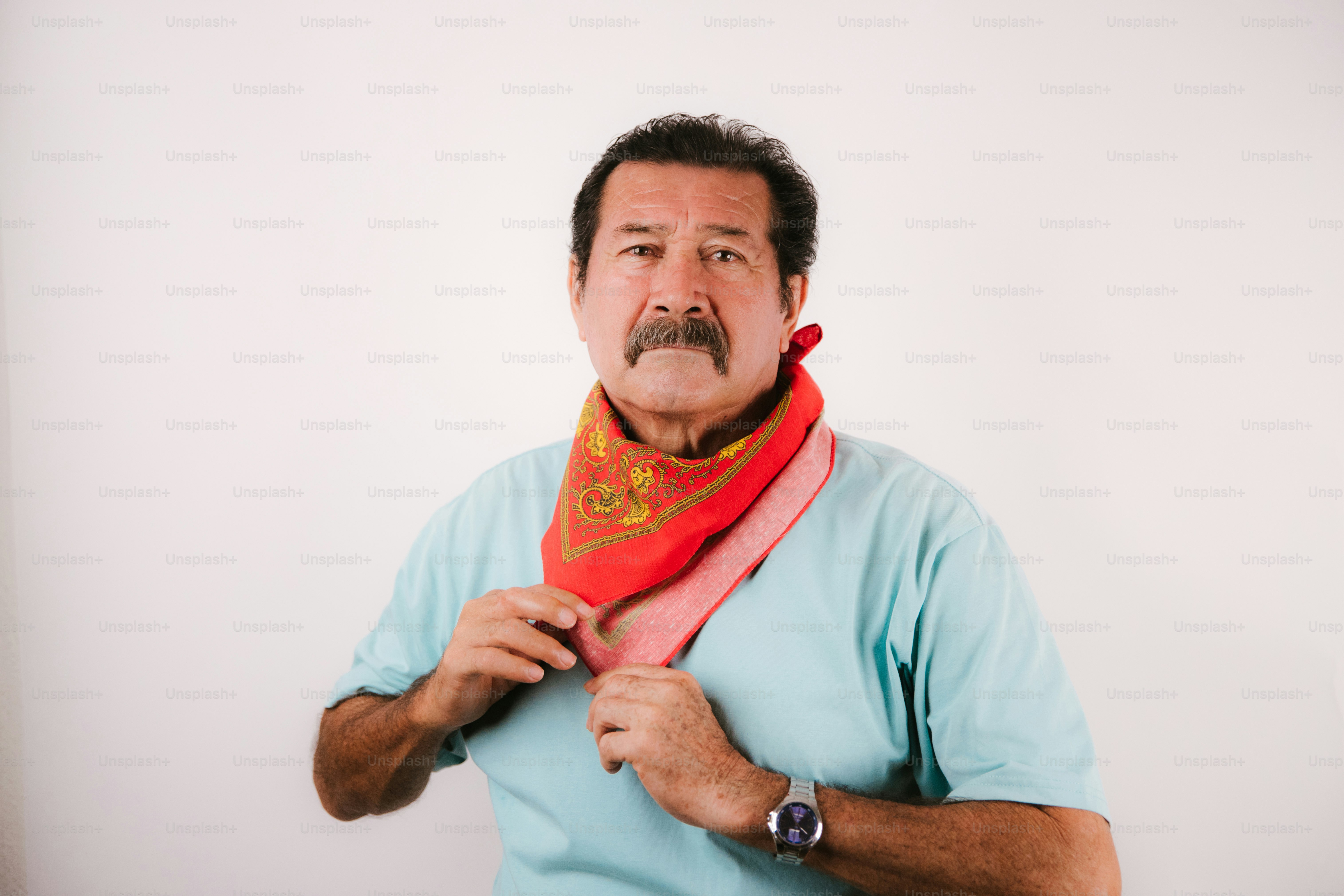 Man adjusting his colorful bandana around his neck