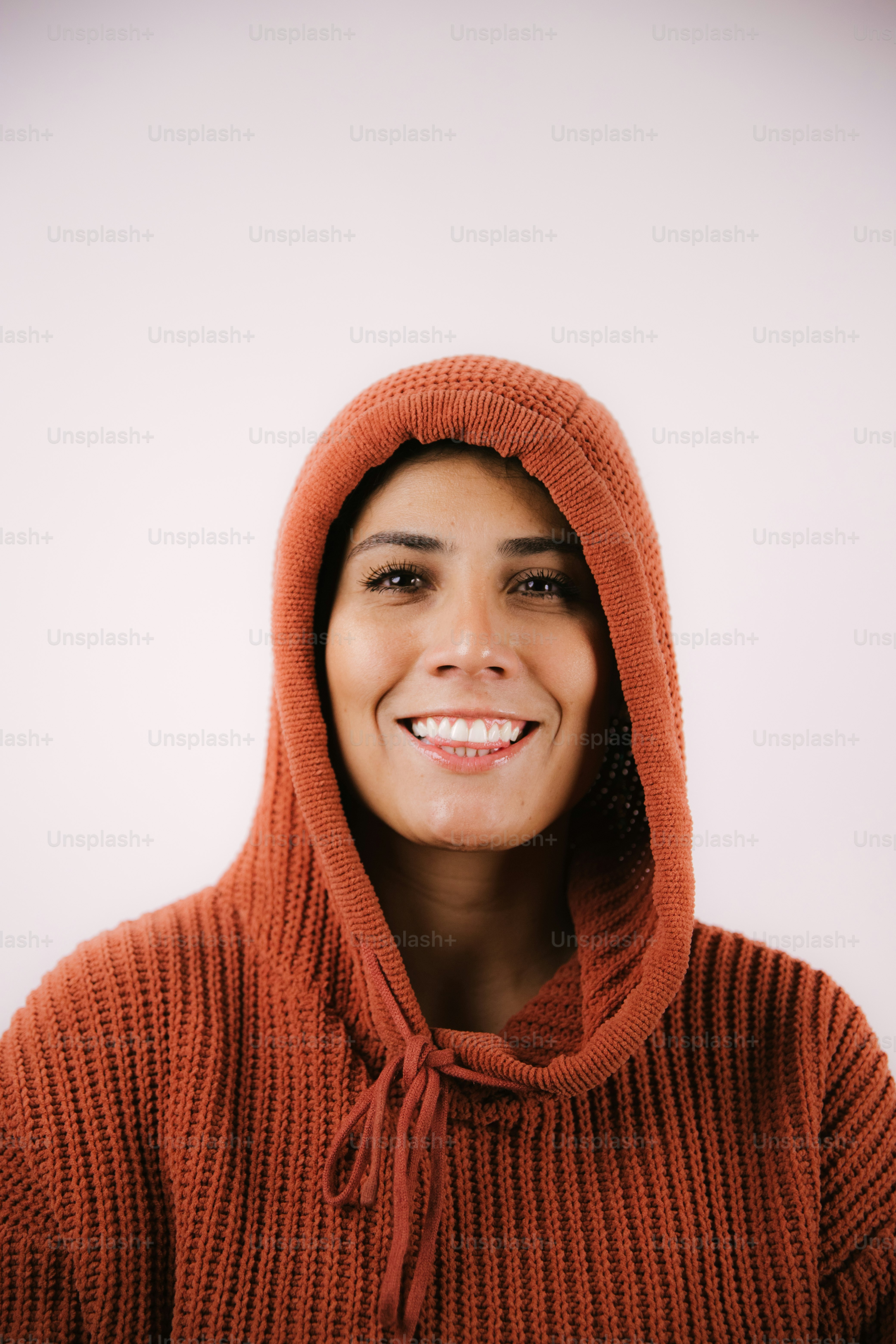 Woman wearing an orange hooded sweater