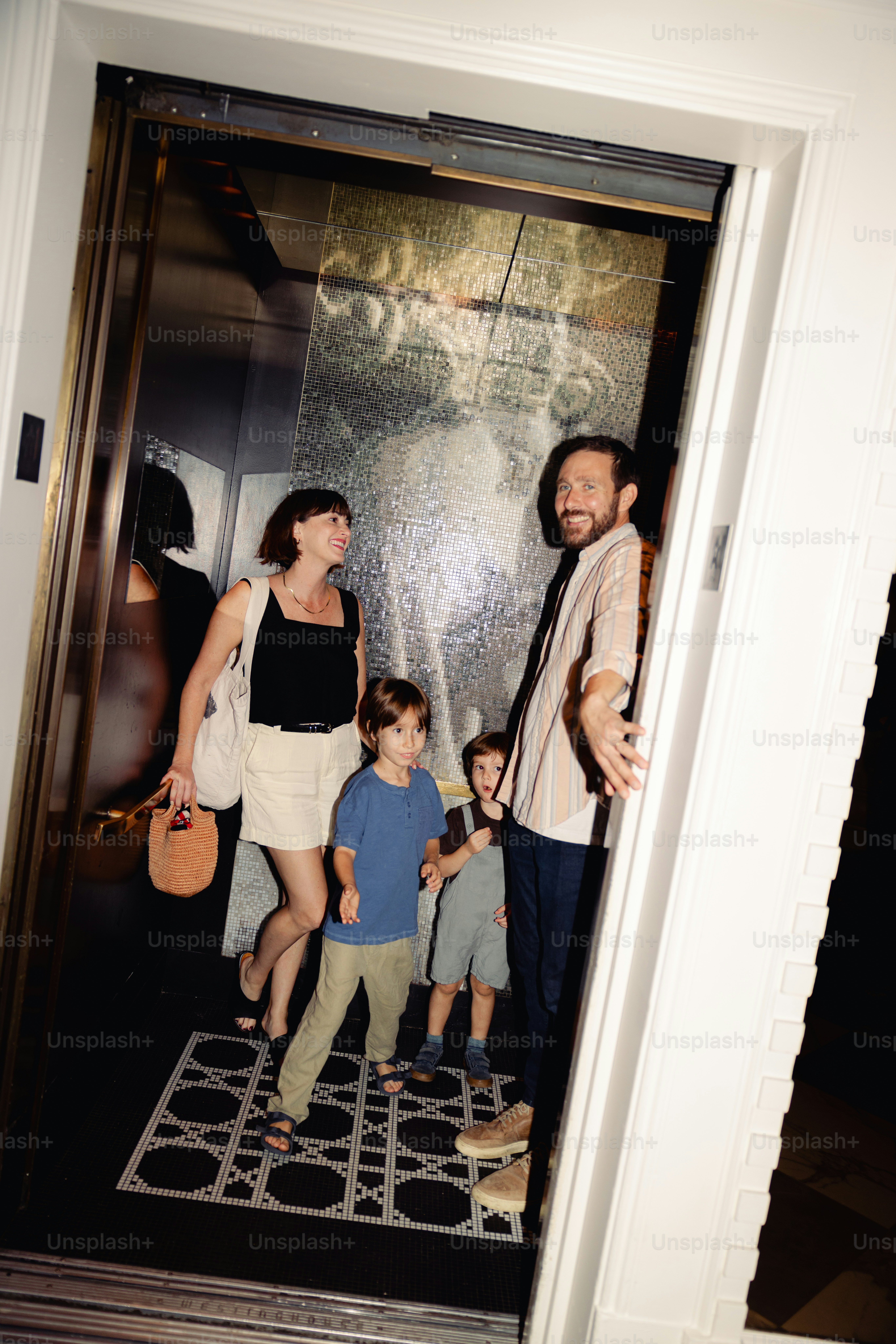 A family of four entering an elevator together