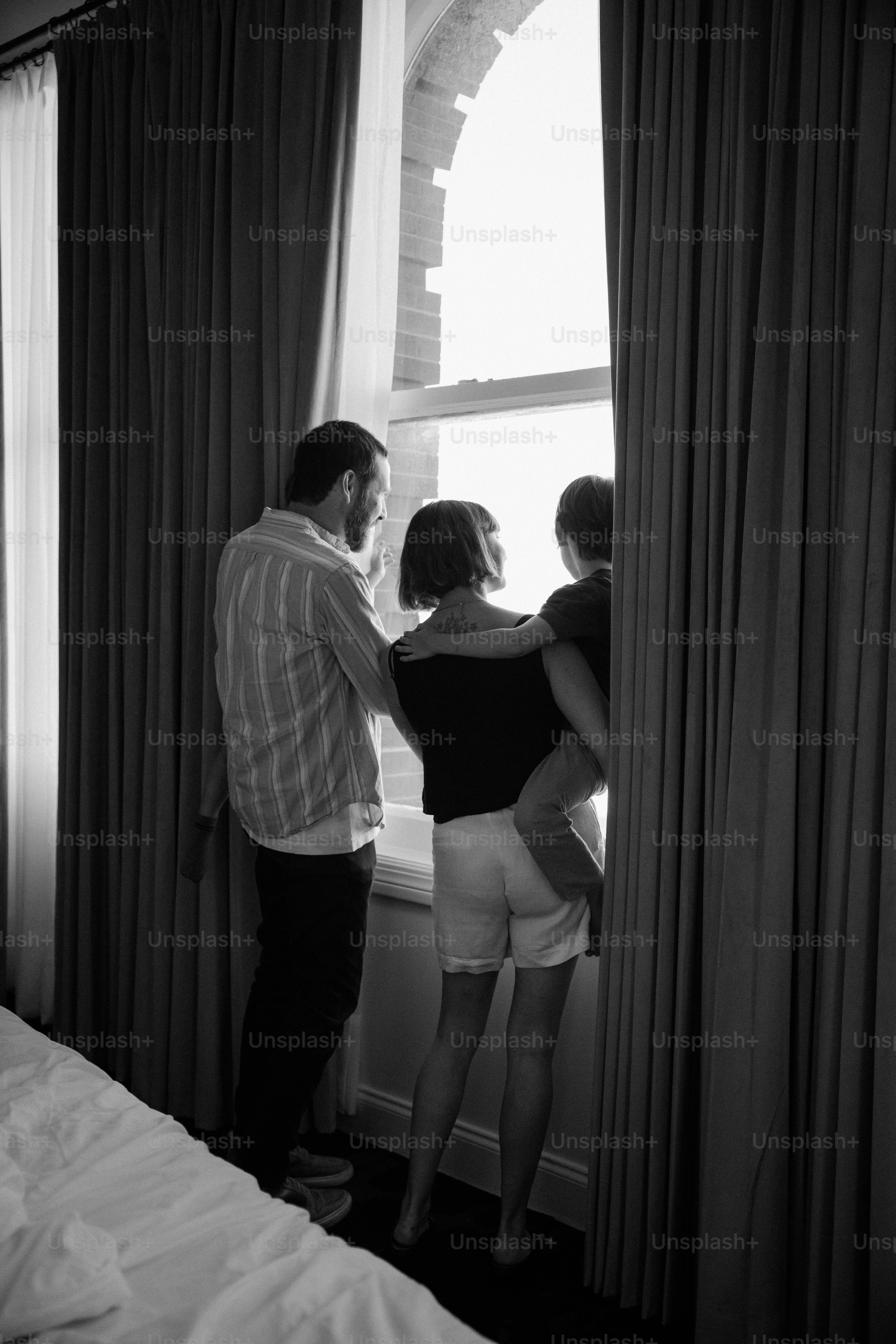 La famiglia si affaccia alla finestra dalla camera d'albergo.