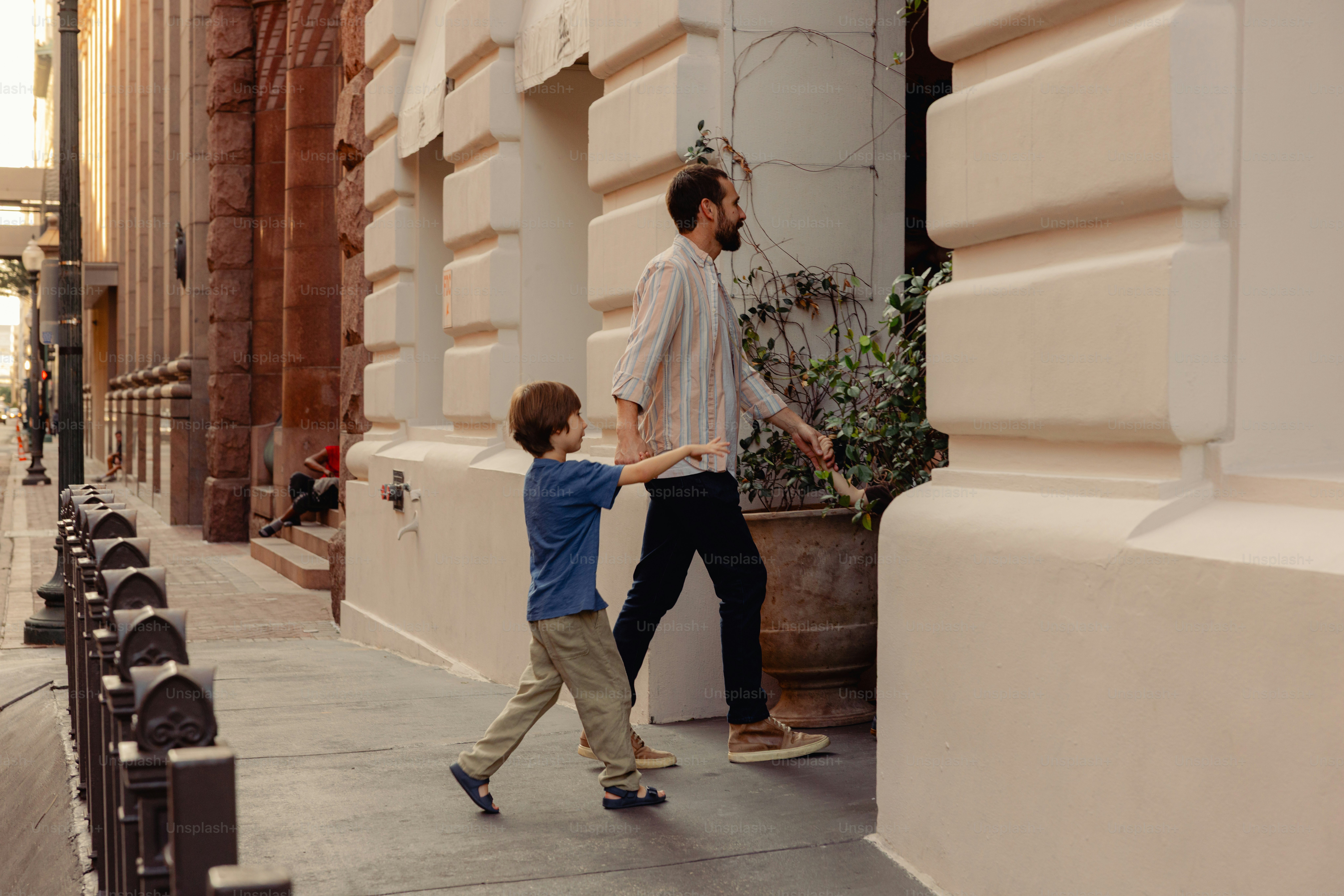 Man and boy walking on city sidewalk photo – Travel Image on Unsplash