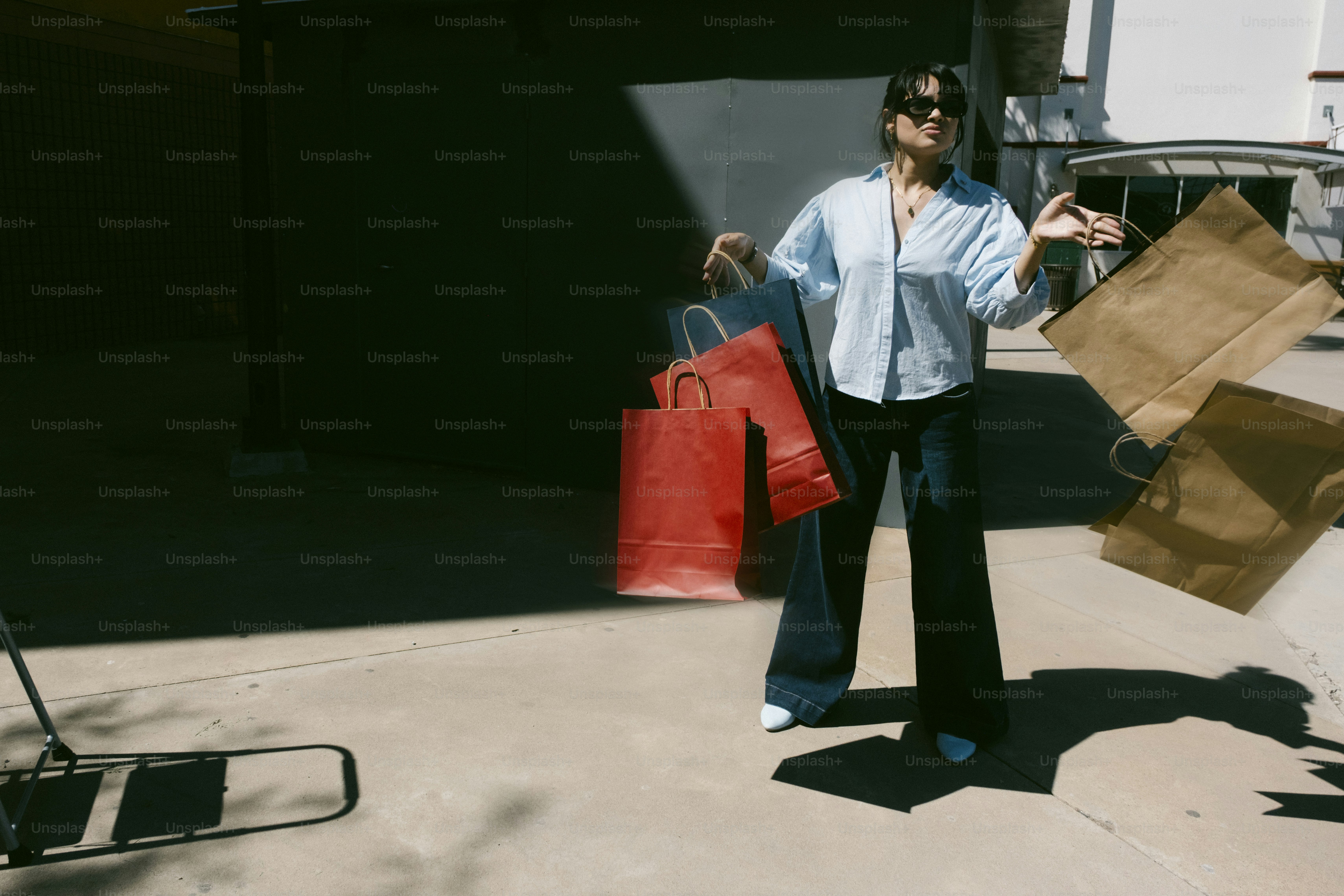 Woman with shopping bags in sunny outdoor setting