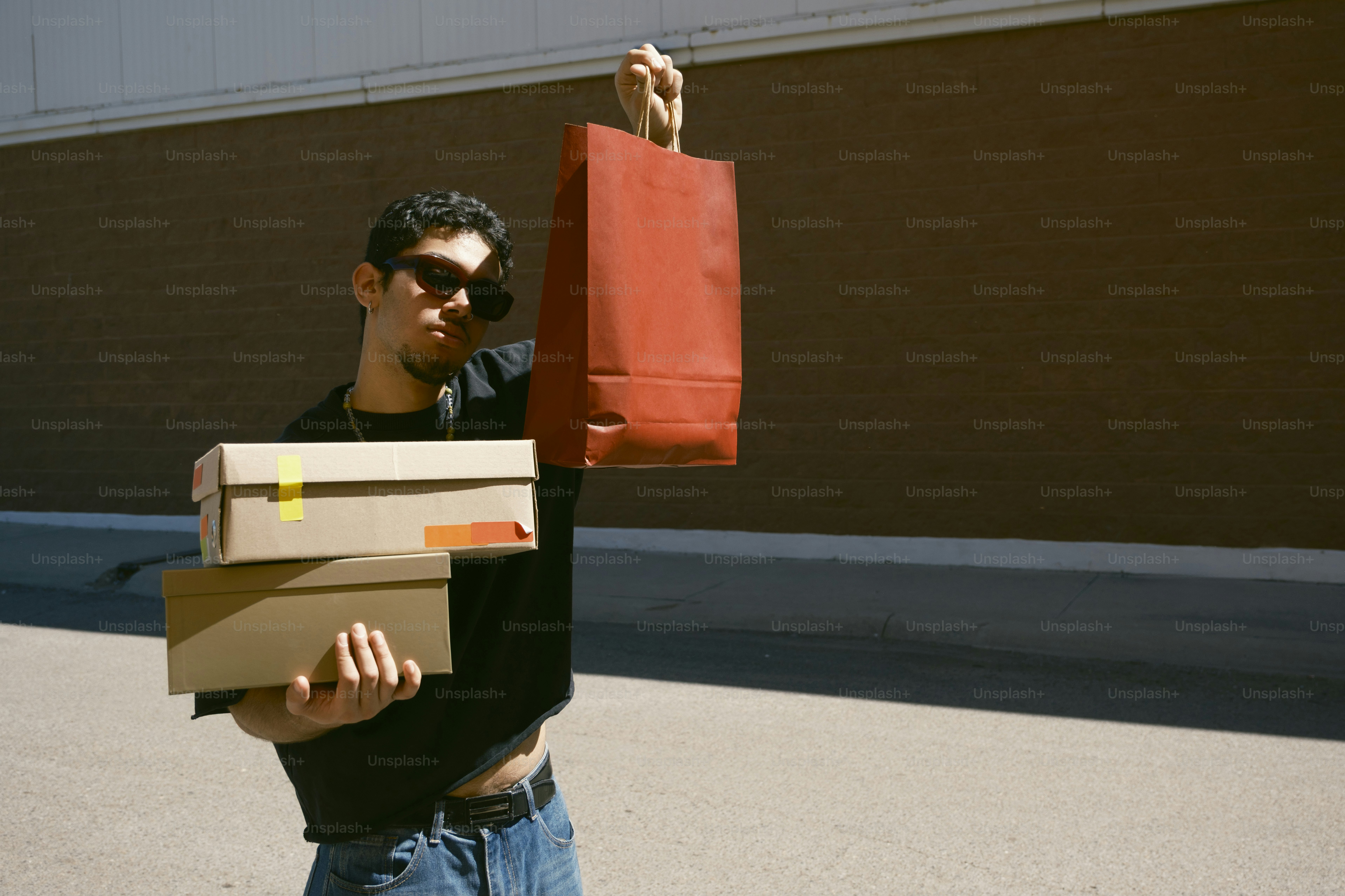 Man holding shopping bags and boxes outdoors