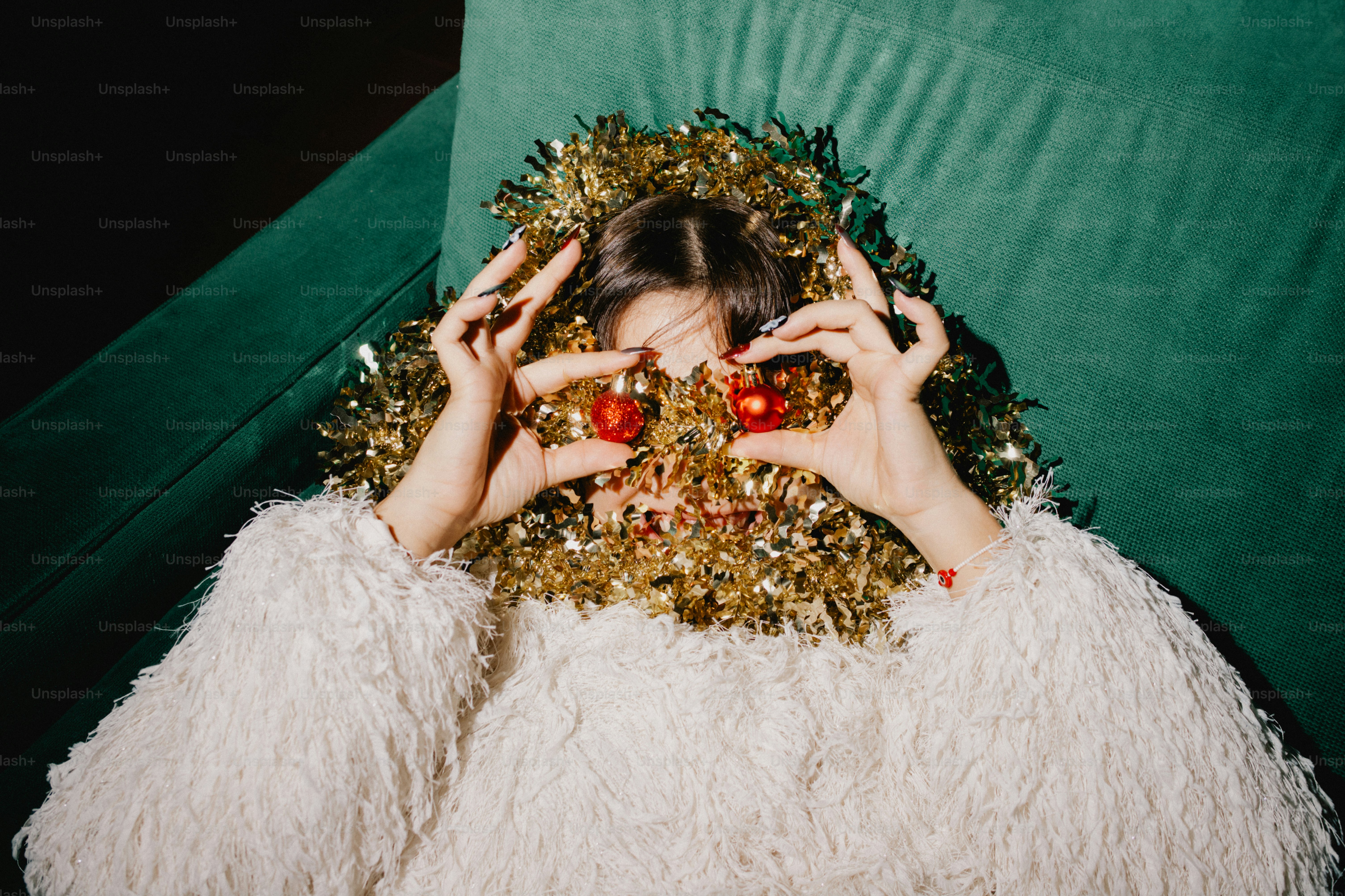 Woman peeking through gold tinsel and ornaments photo  Christmas Image on  Unsplash