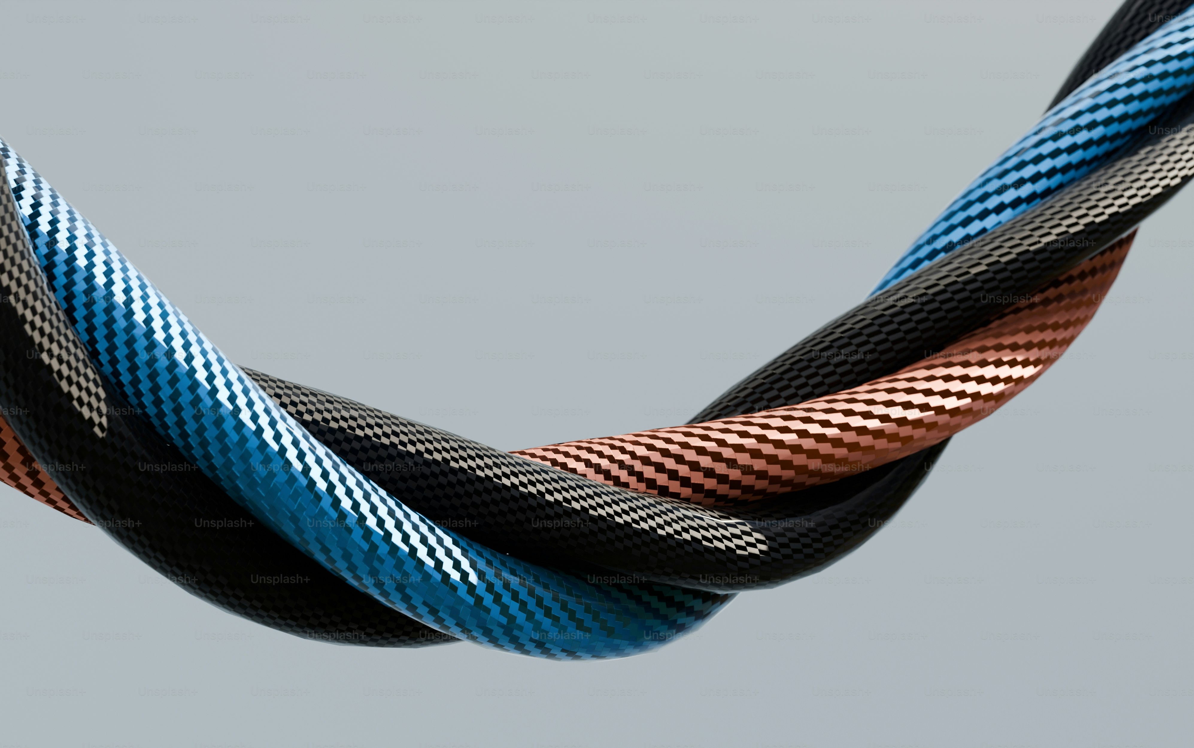 Three braided cables twisted together on gray background