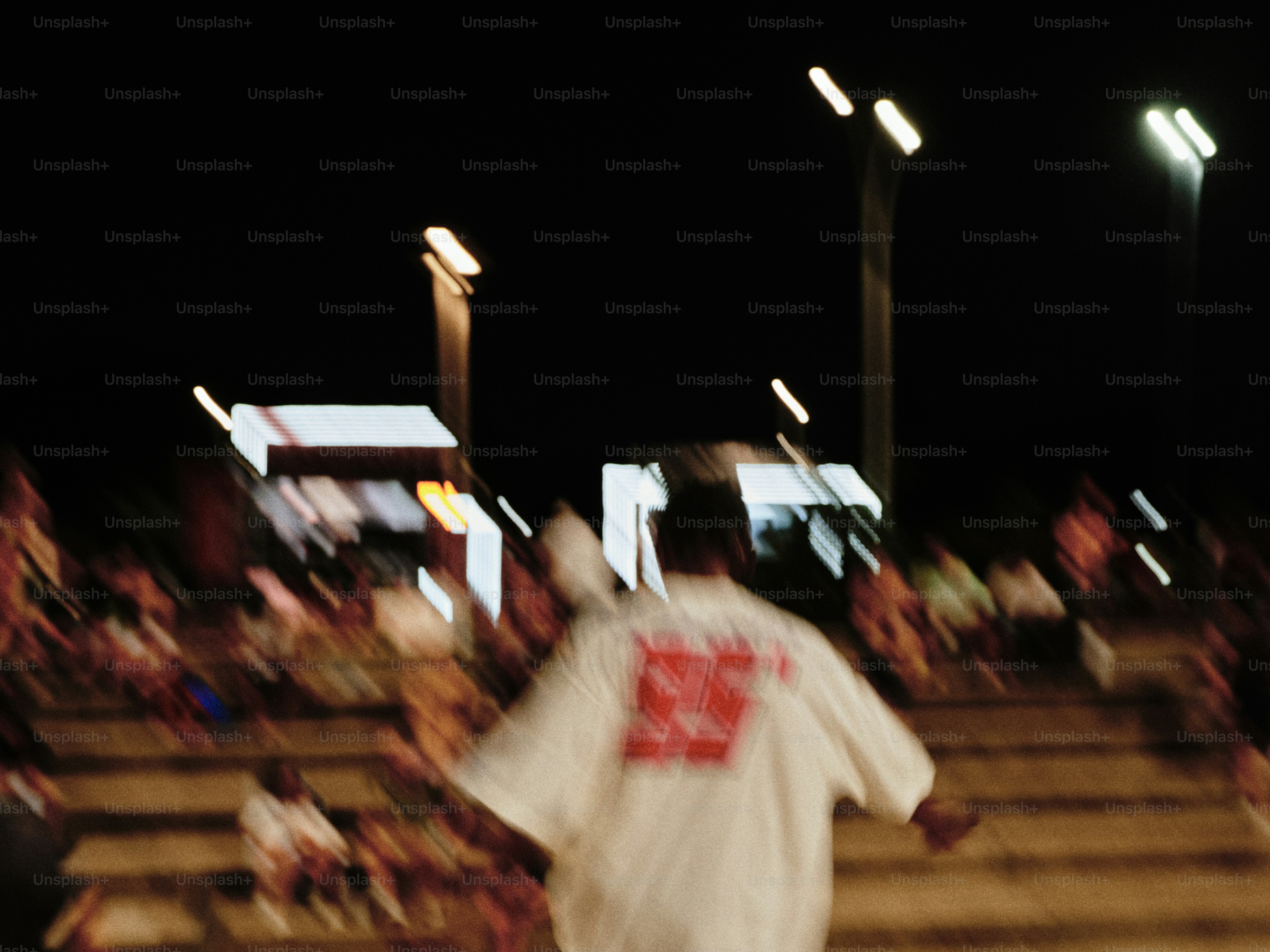 Man in white shirt walking at night event