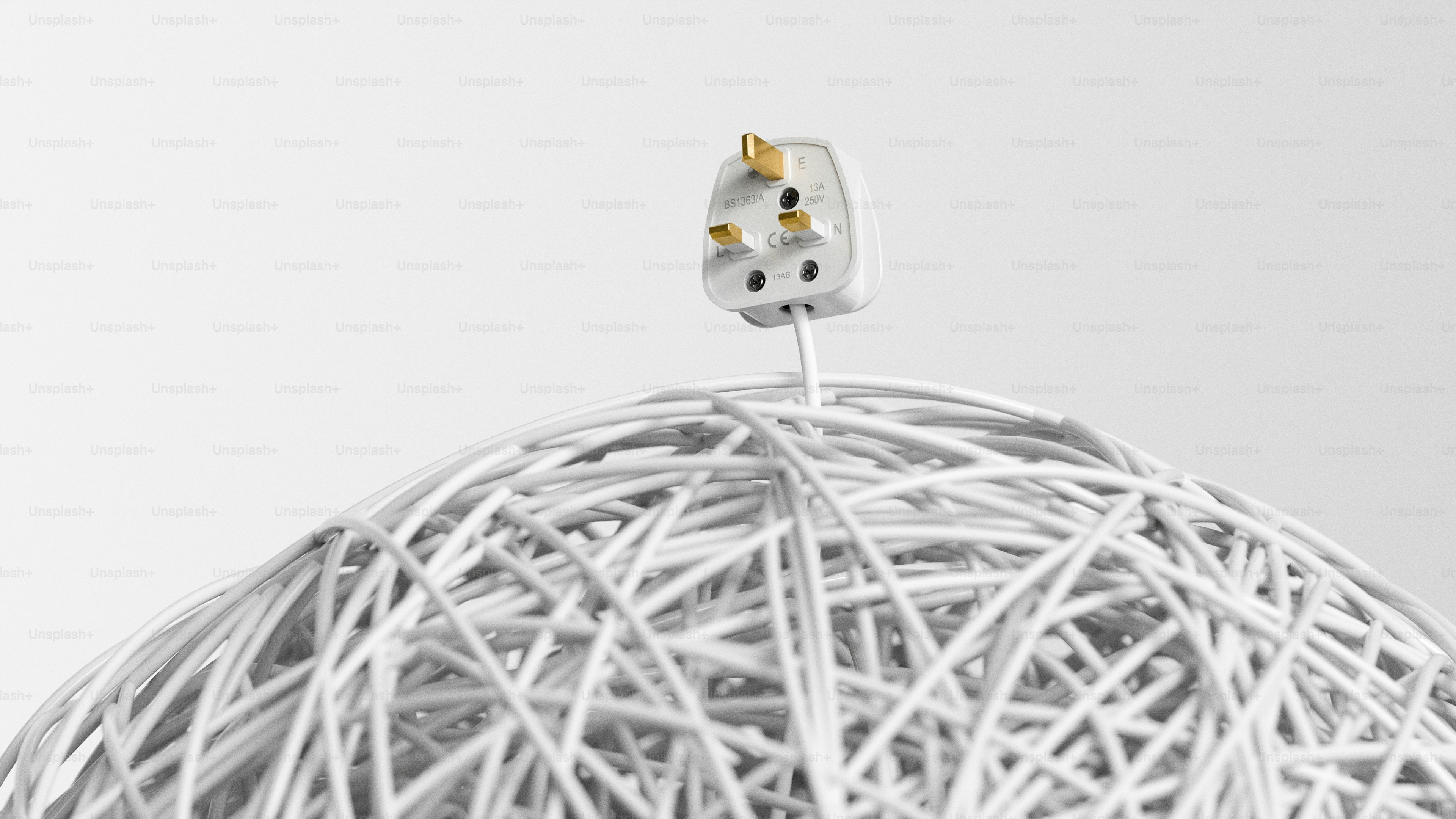 Electrical plug atop tangled white wires