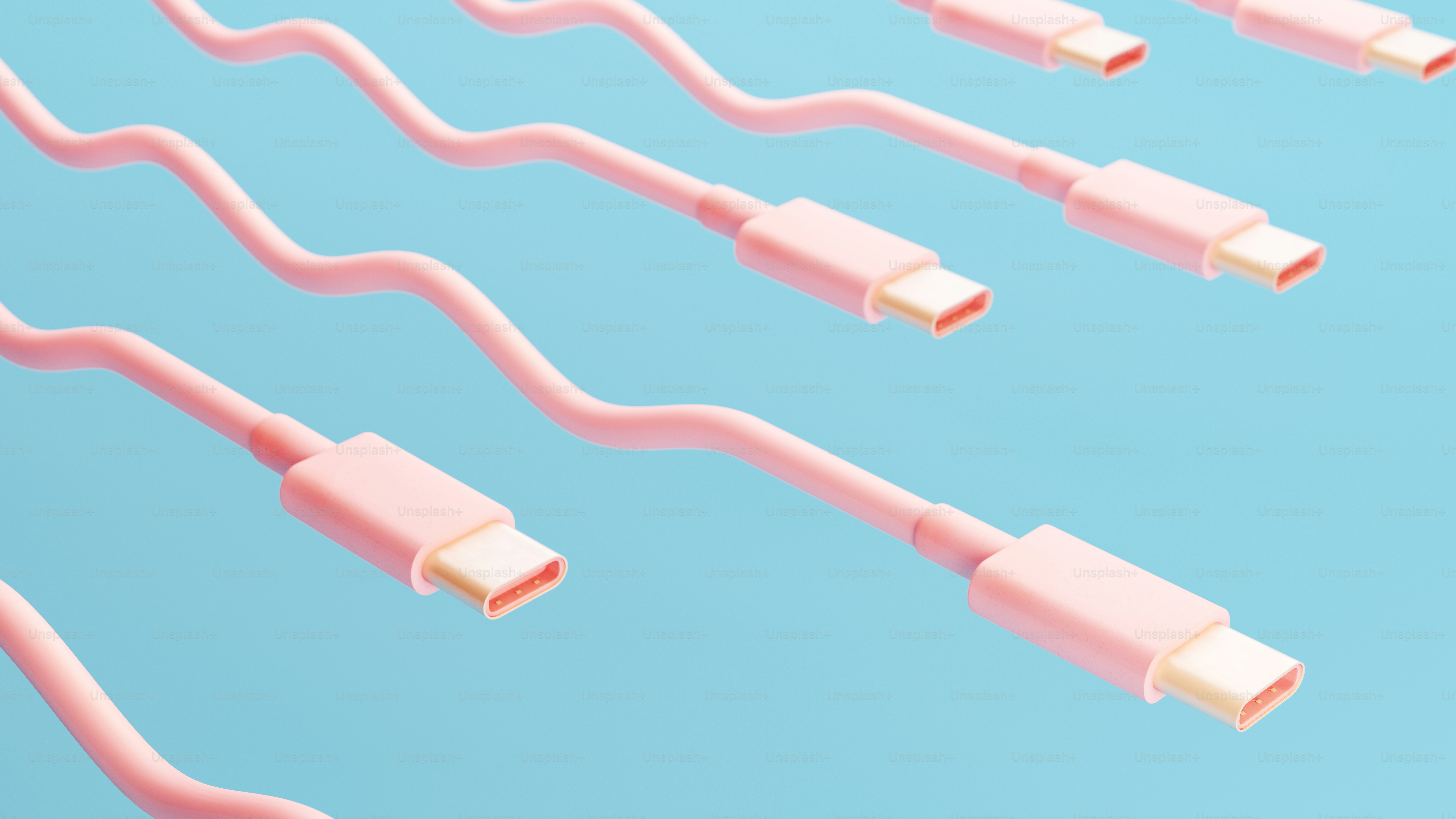Plusieurs câbles USB-C roses sur fond bleu