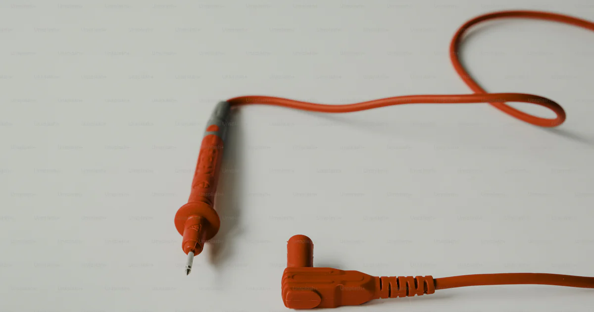 Two red electrical test leads on white surface photo – Technology Image ...