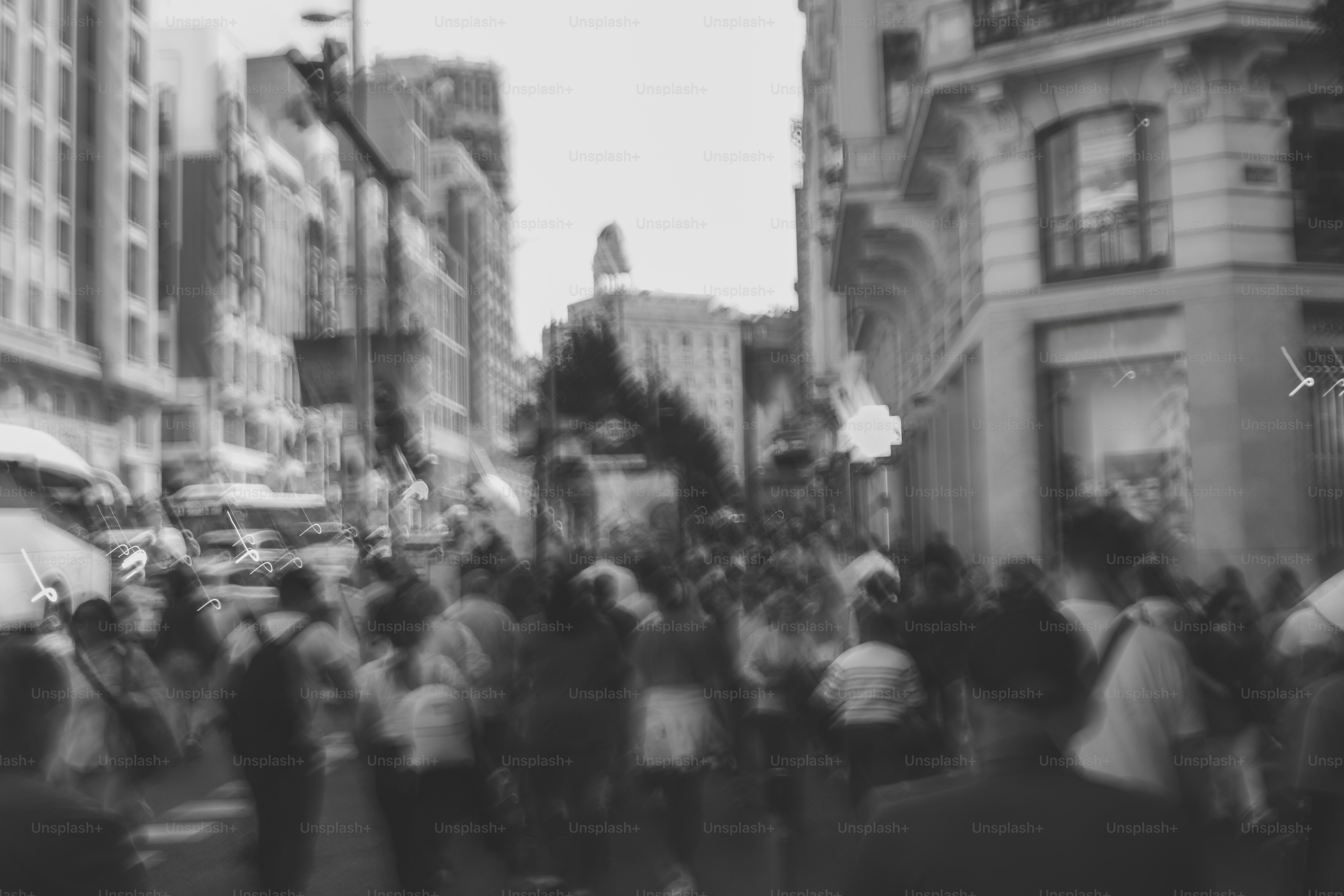 Blurred black and white street scene with many people