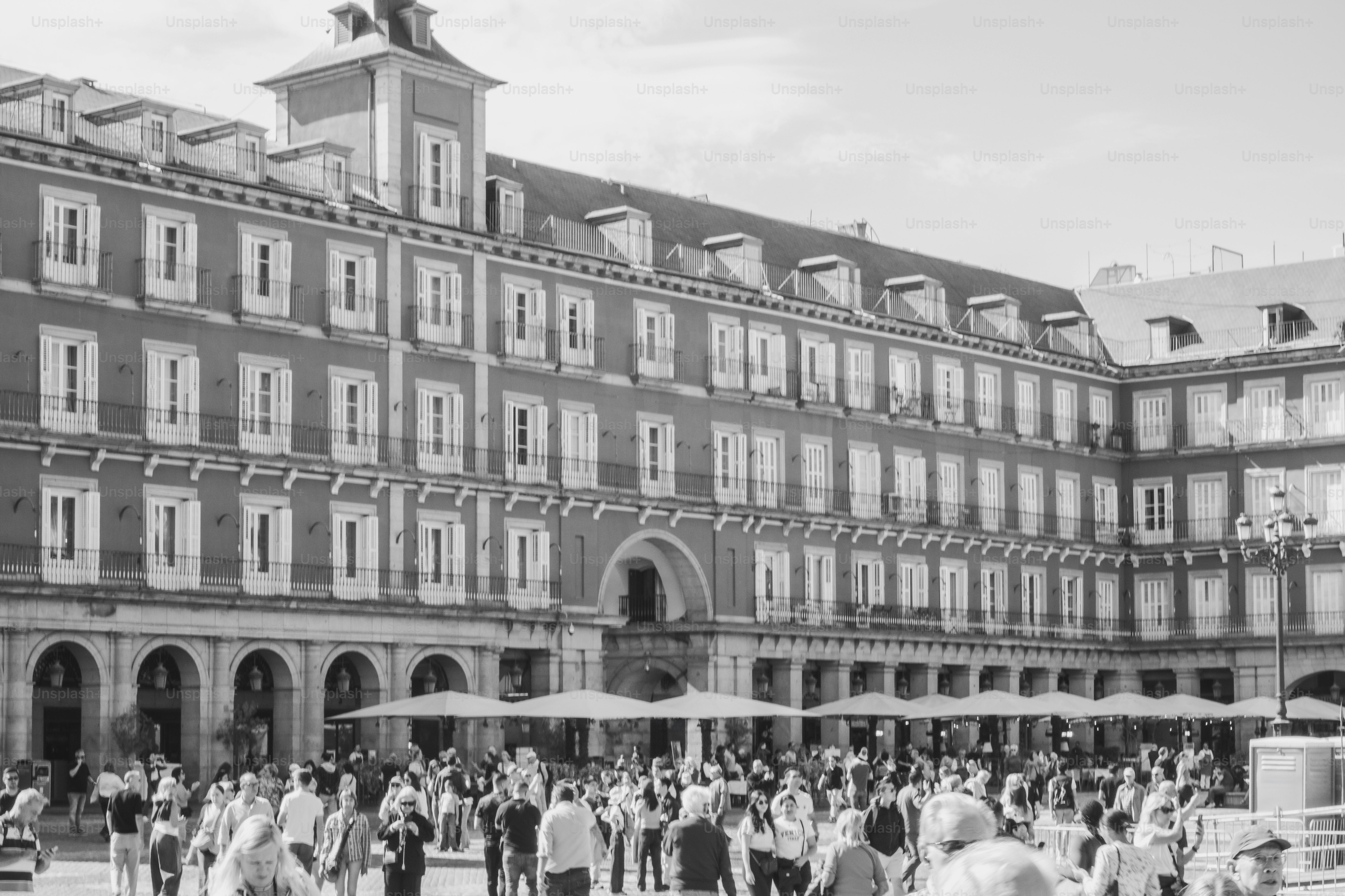 People gathered in a european plaza with historic buildings