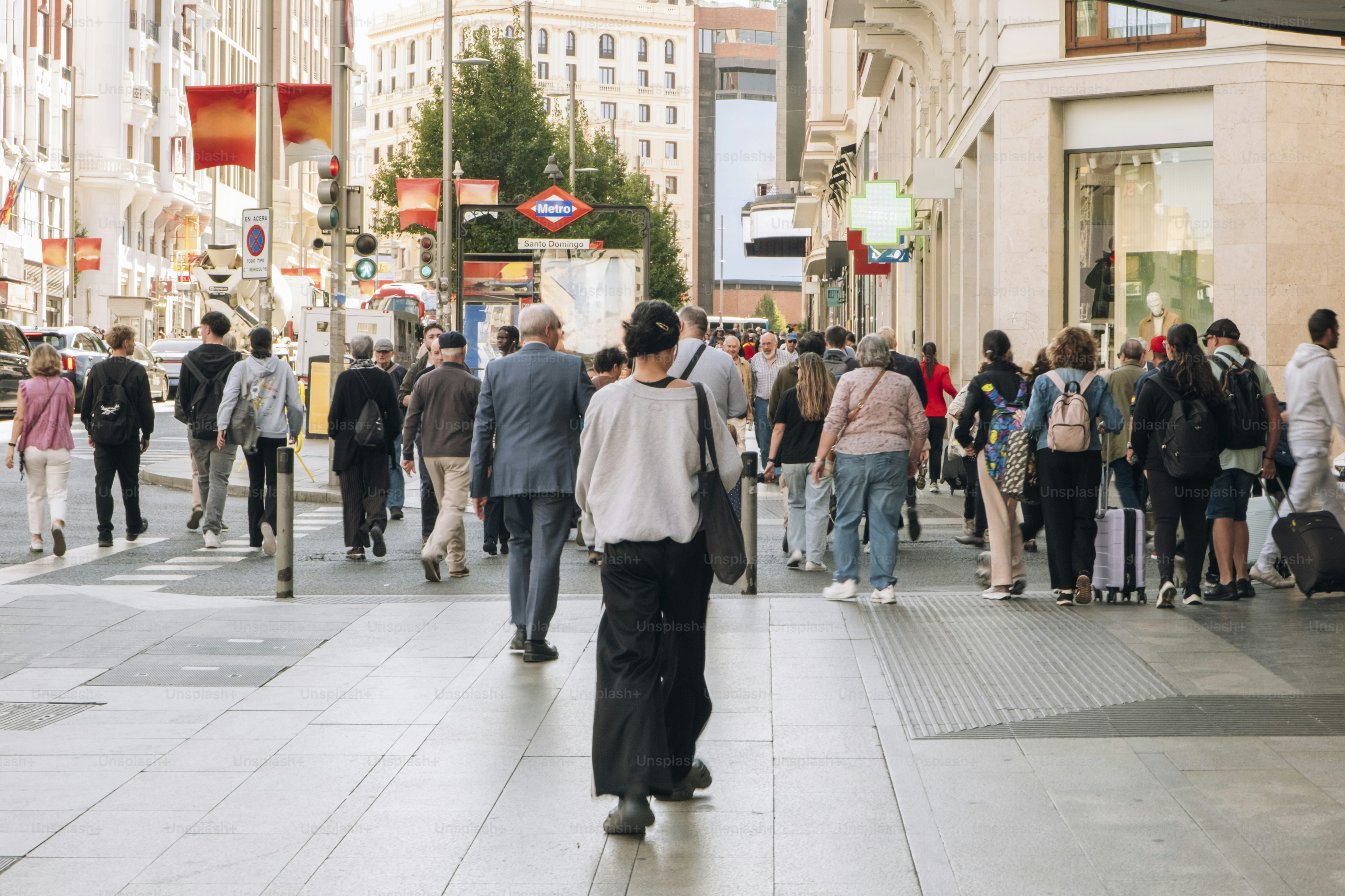 Traveler using carry-on backpack vs suitcase on European city street
