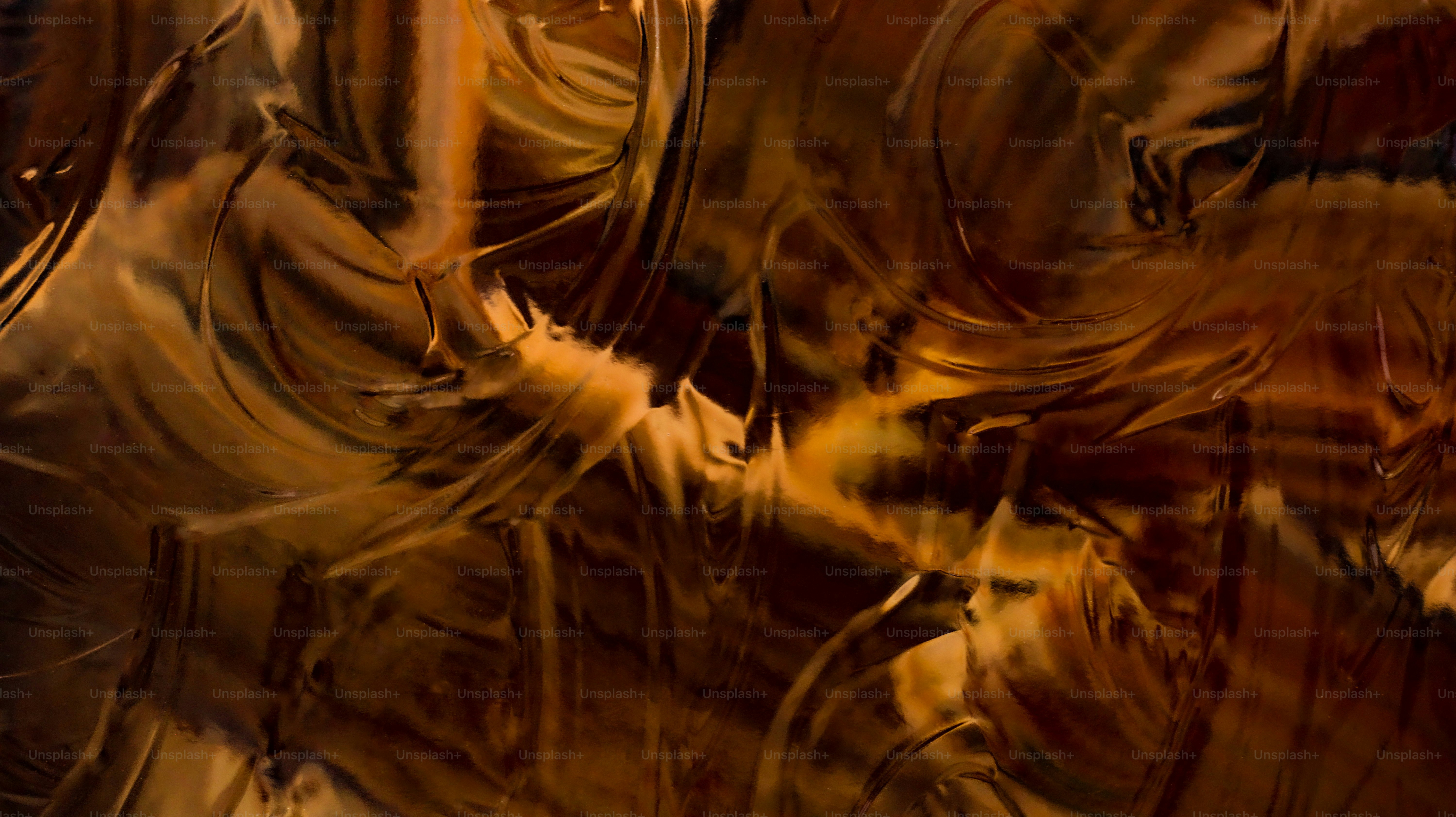 Abstract swirling patterns in brown and gold tones