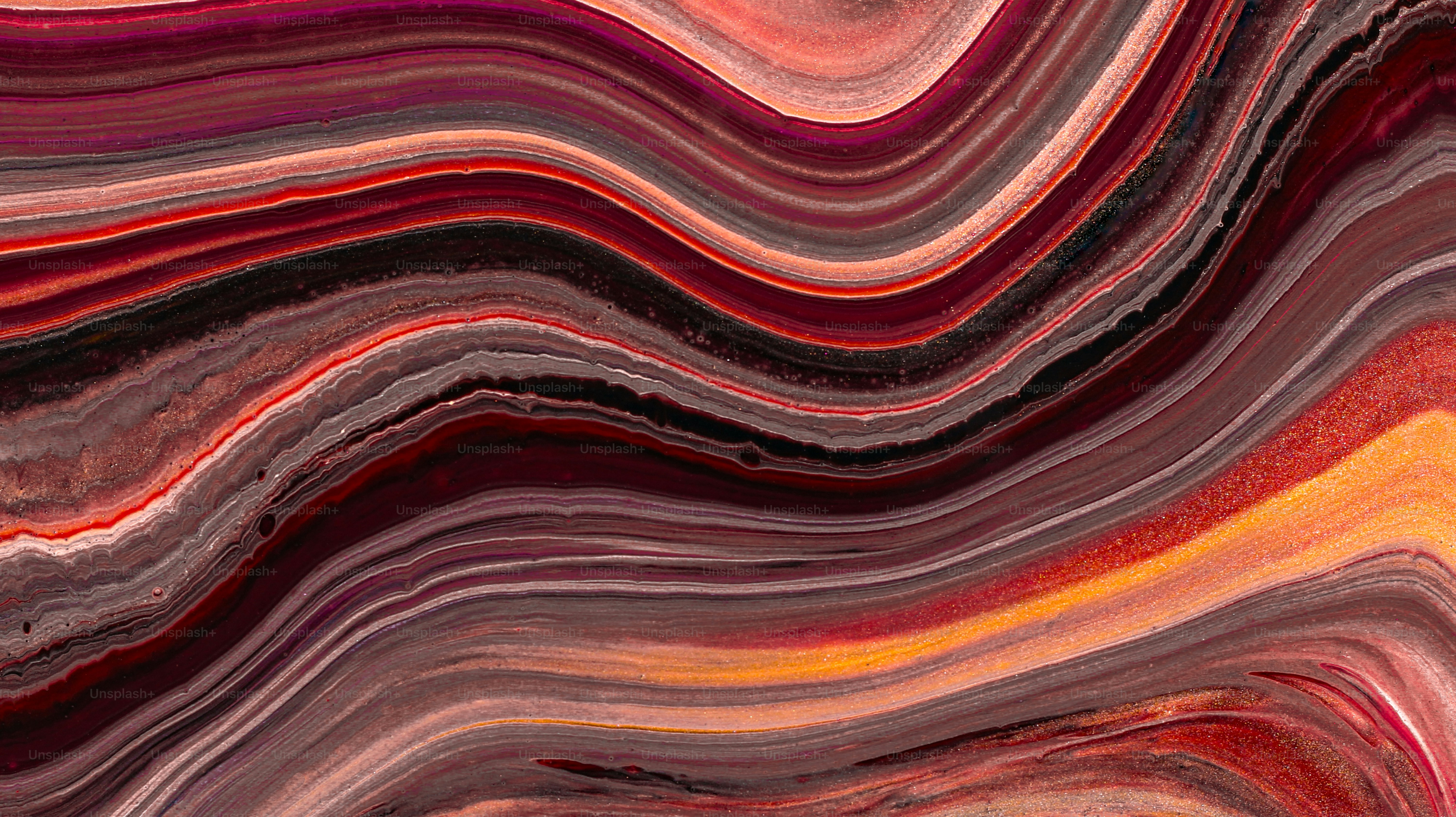 Abstract swirling colors of red, brown, and orange.