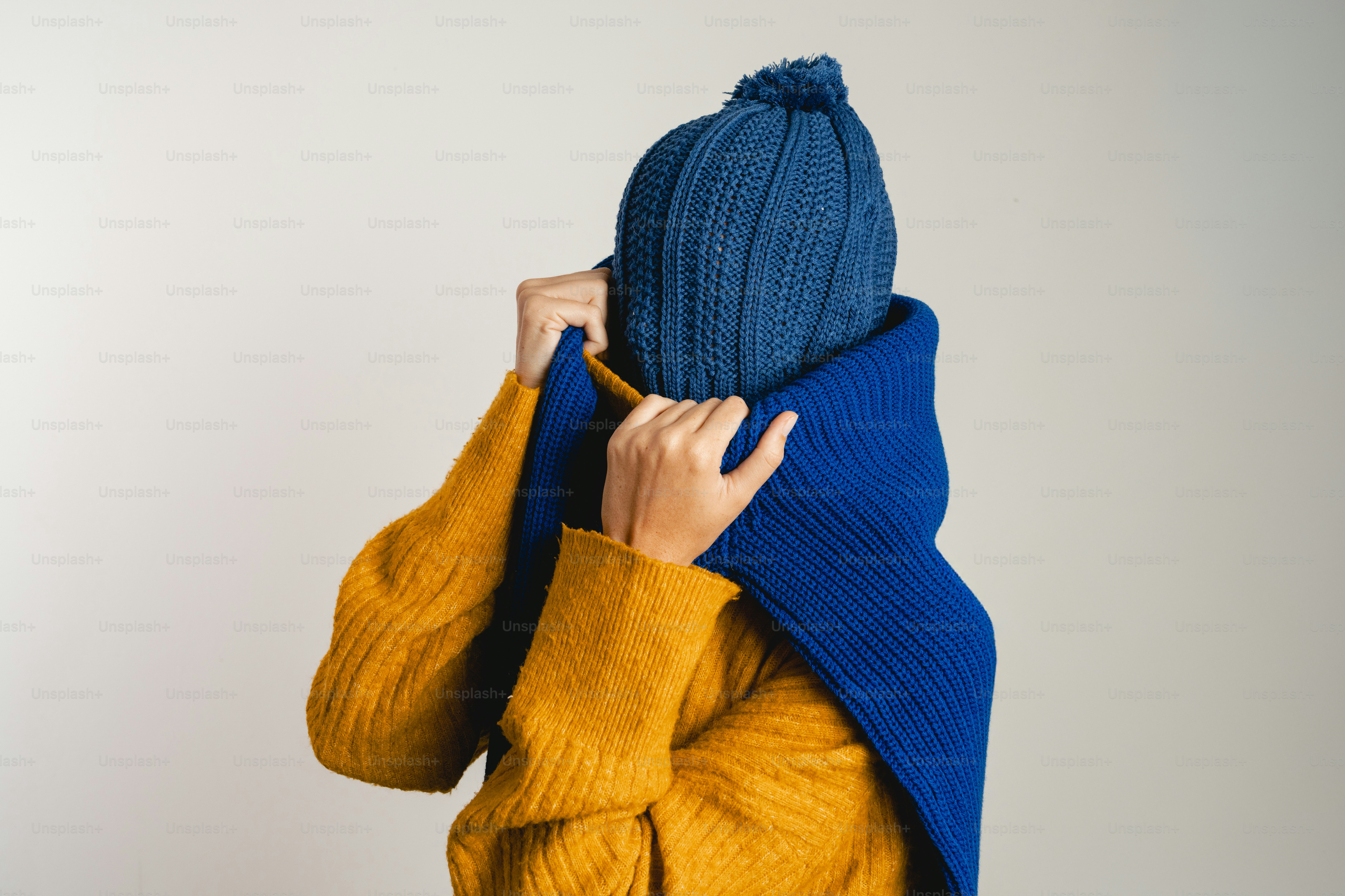 Person bundled in blue hat and scarf