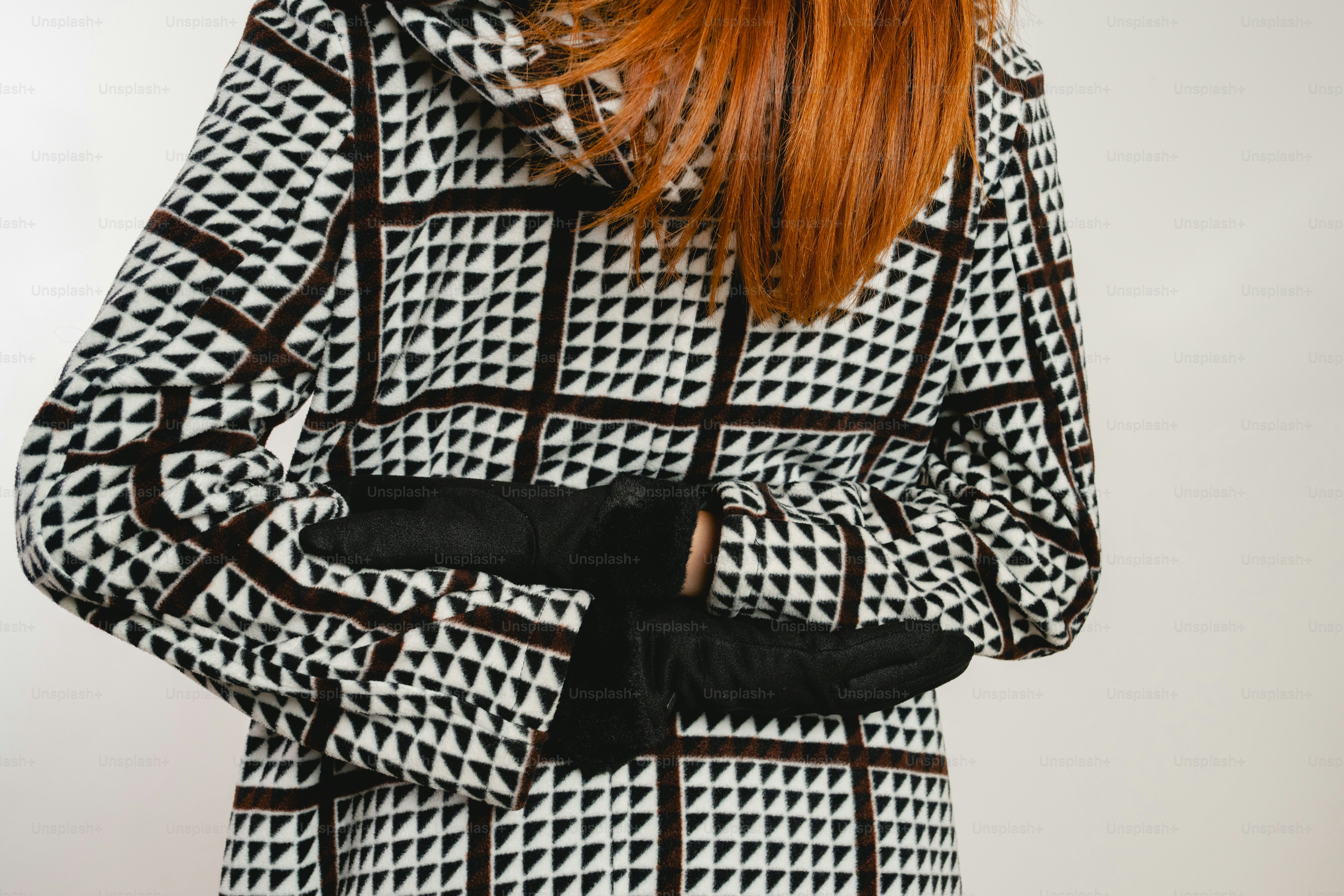 Woman in patterned coat with hands behind back