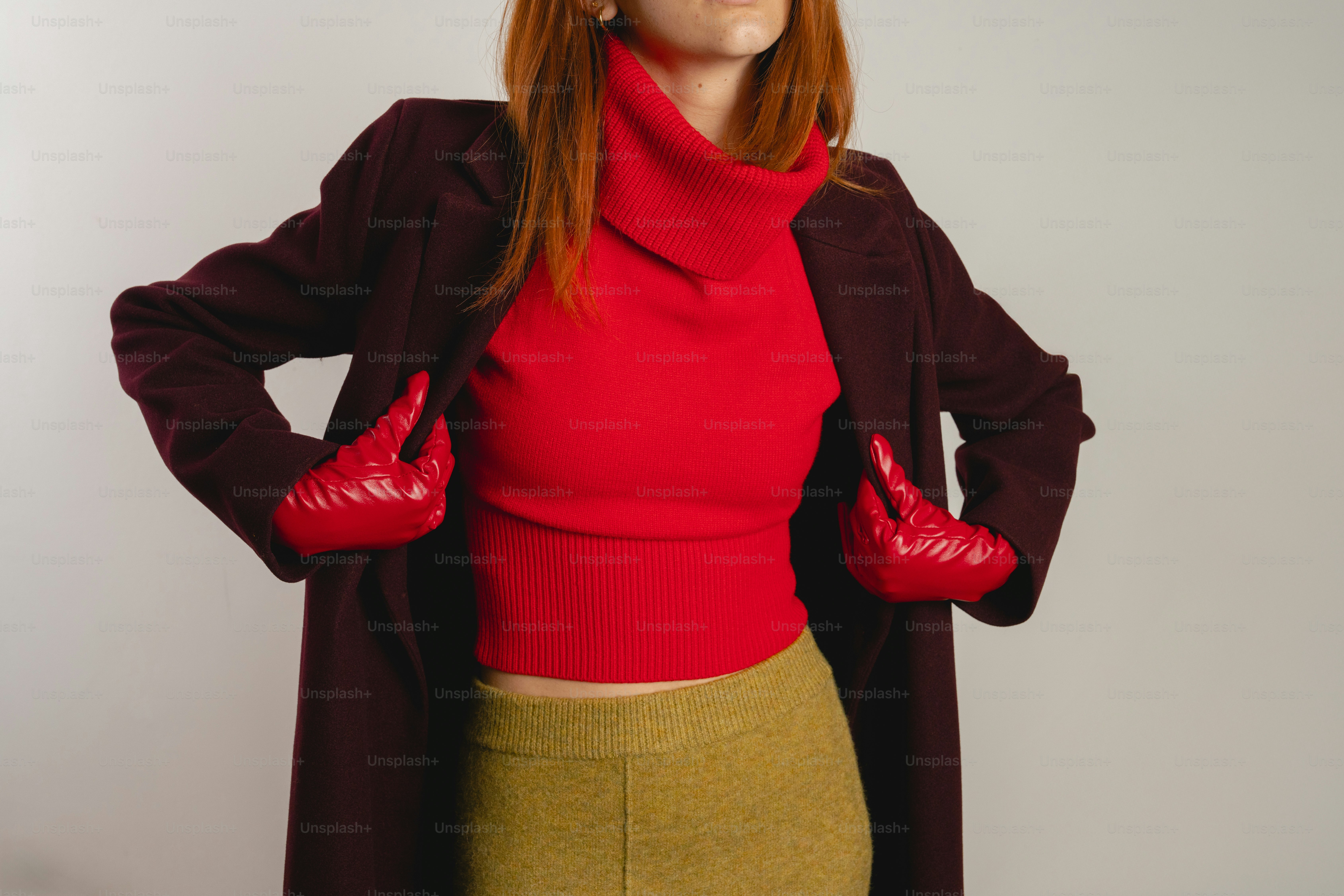 Woman in red turtleneck, gloves, and coat