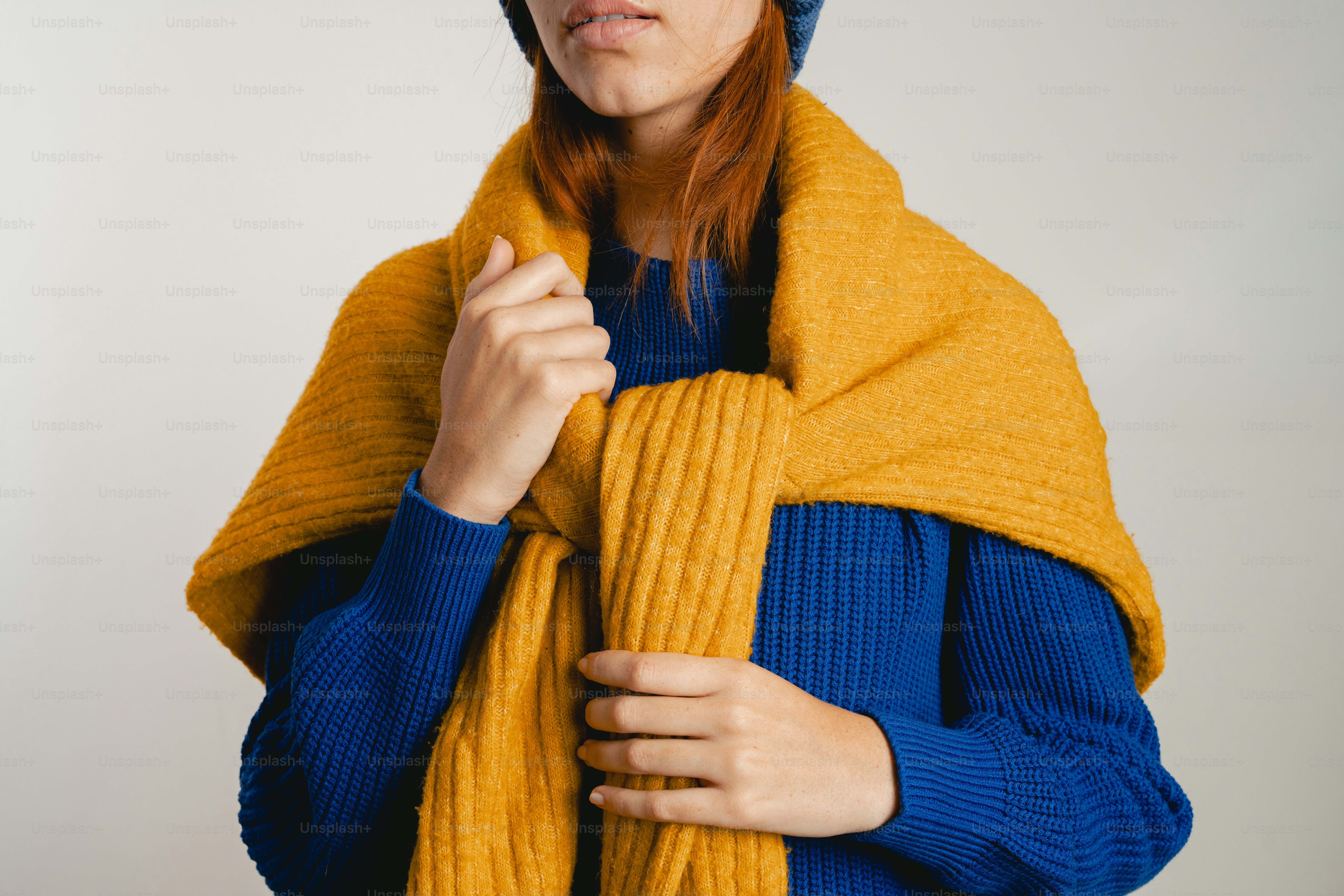 Woman in blue sweater and yellow scarf