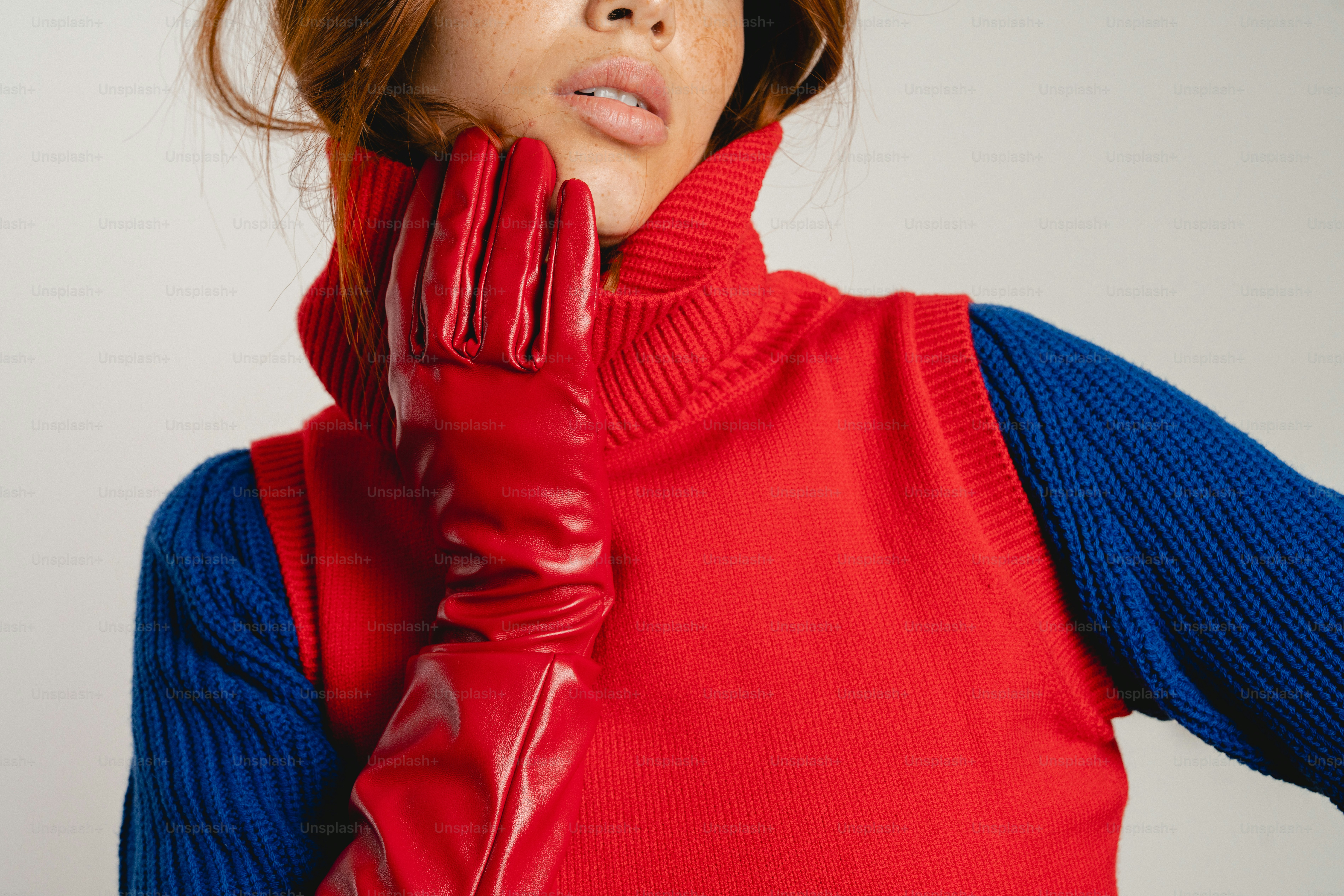 Woman wears red gloves and colorful sweater