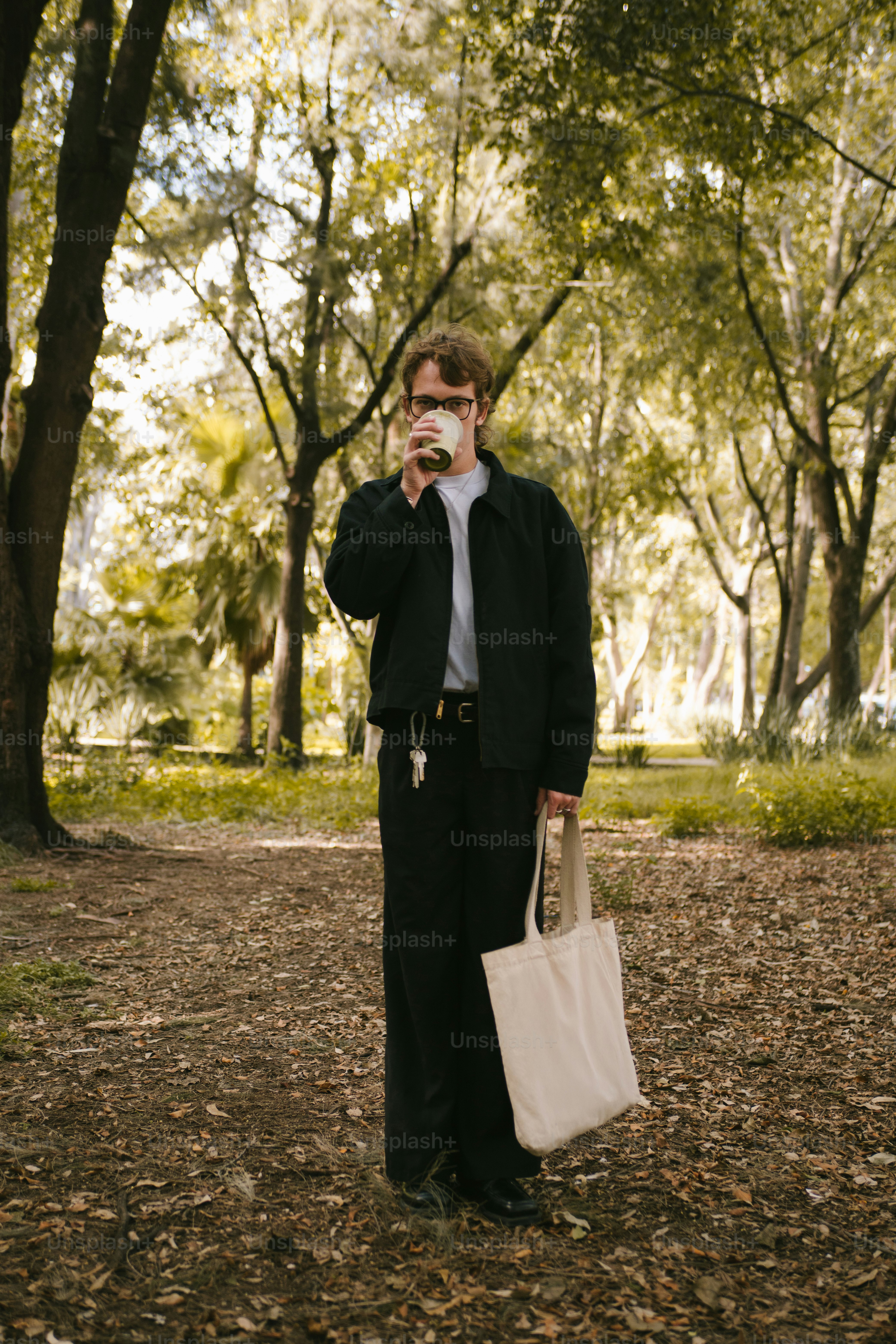 Man drinking coffee in a park