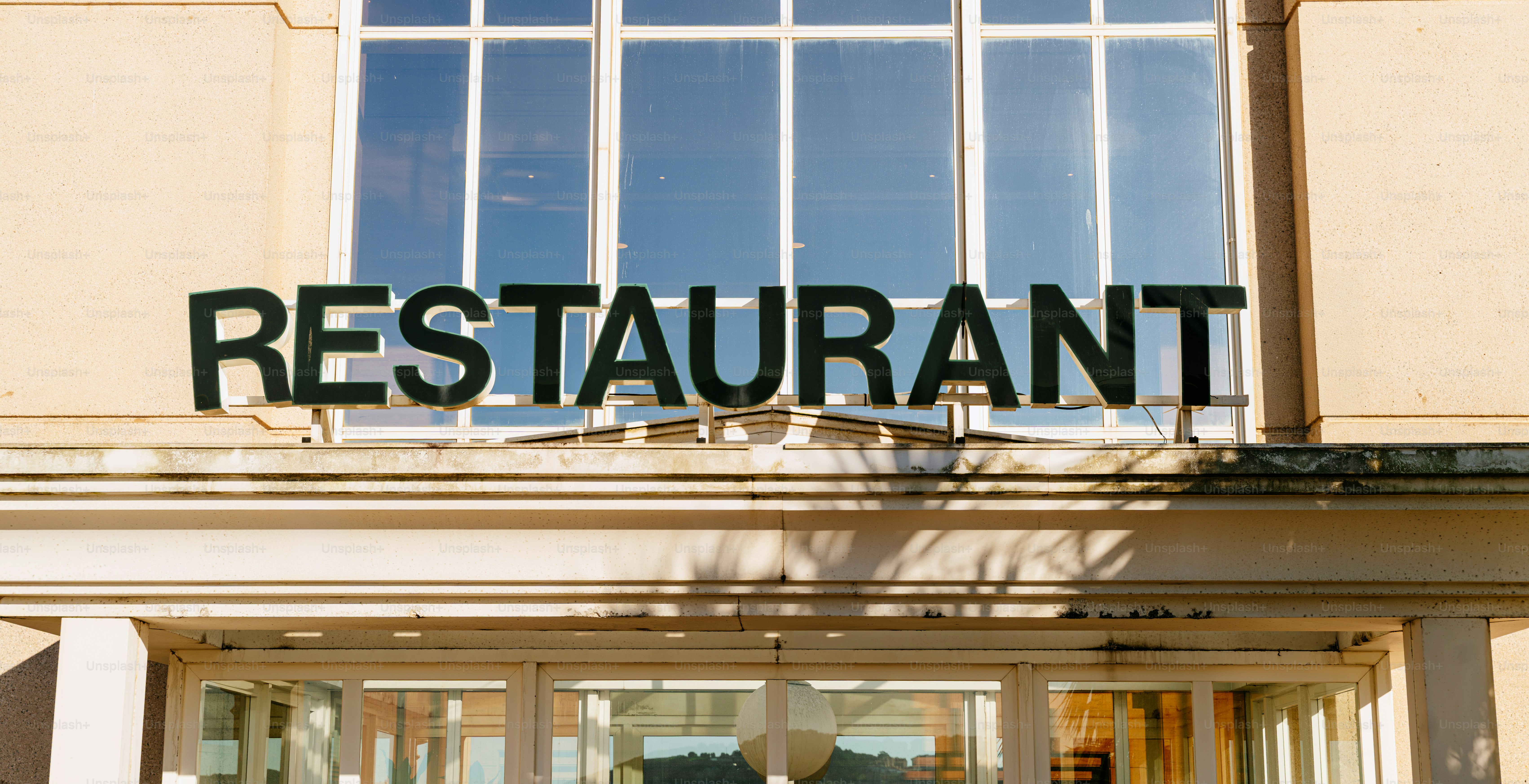 A restaurant sign above a building entrance.