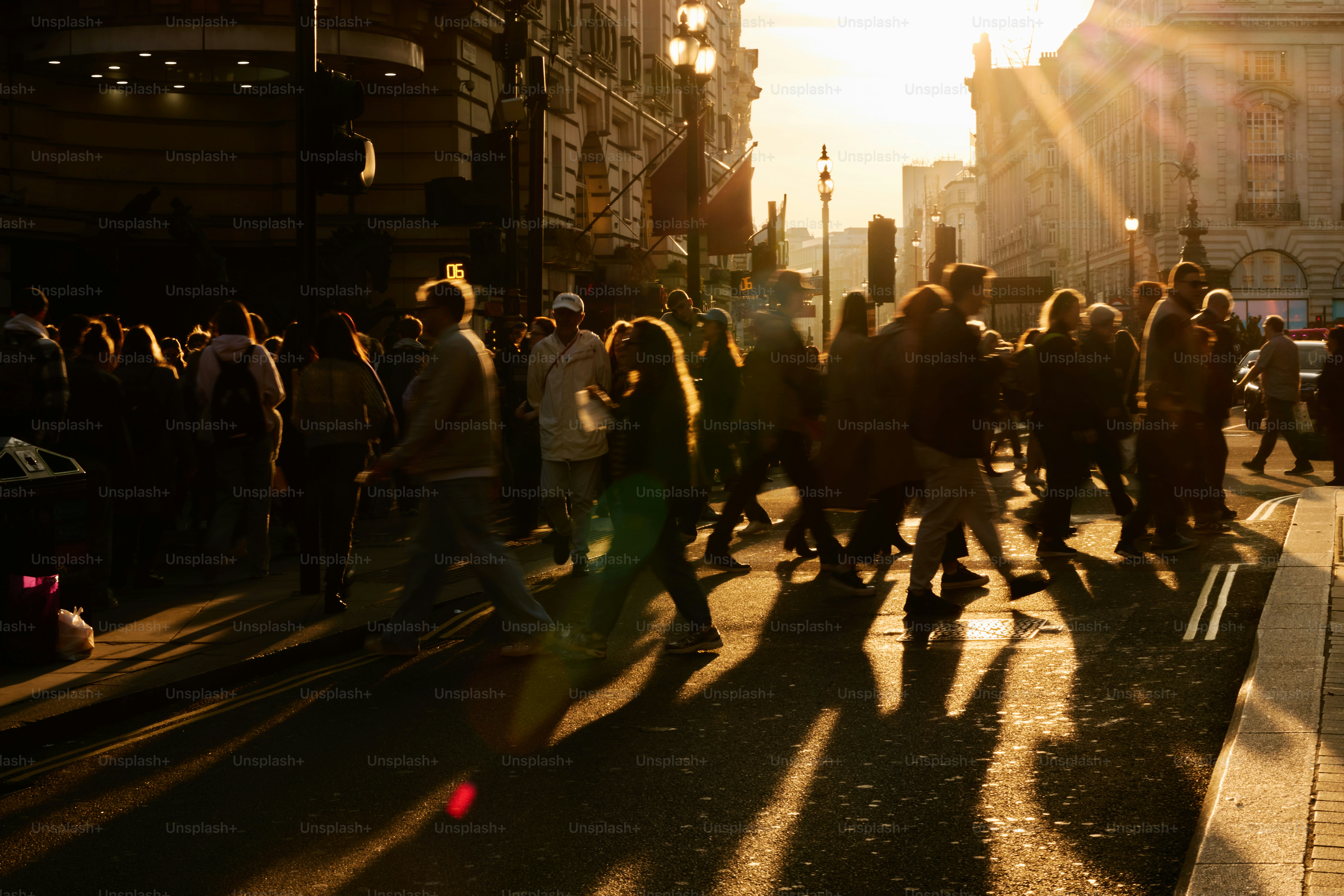 People walking on a street at sunset