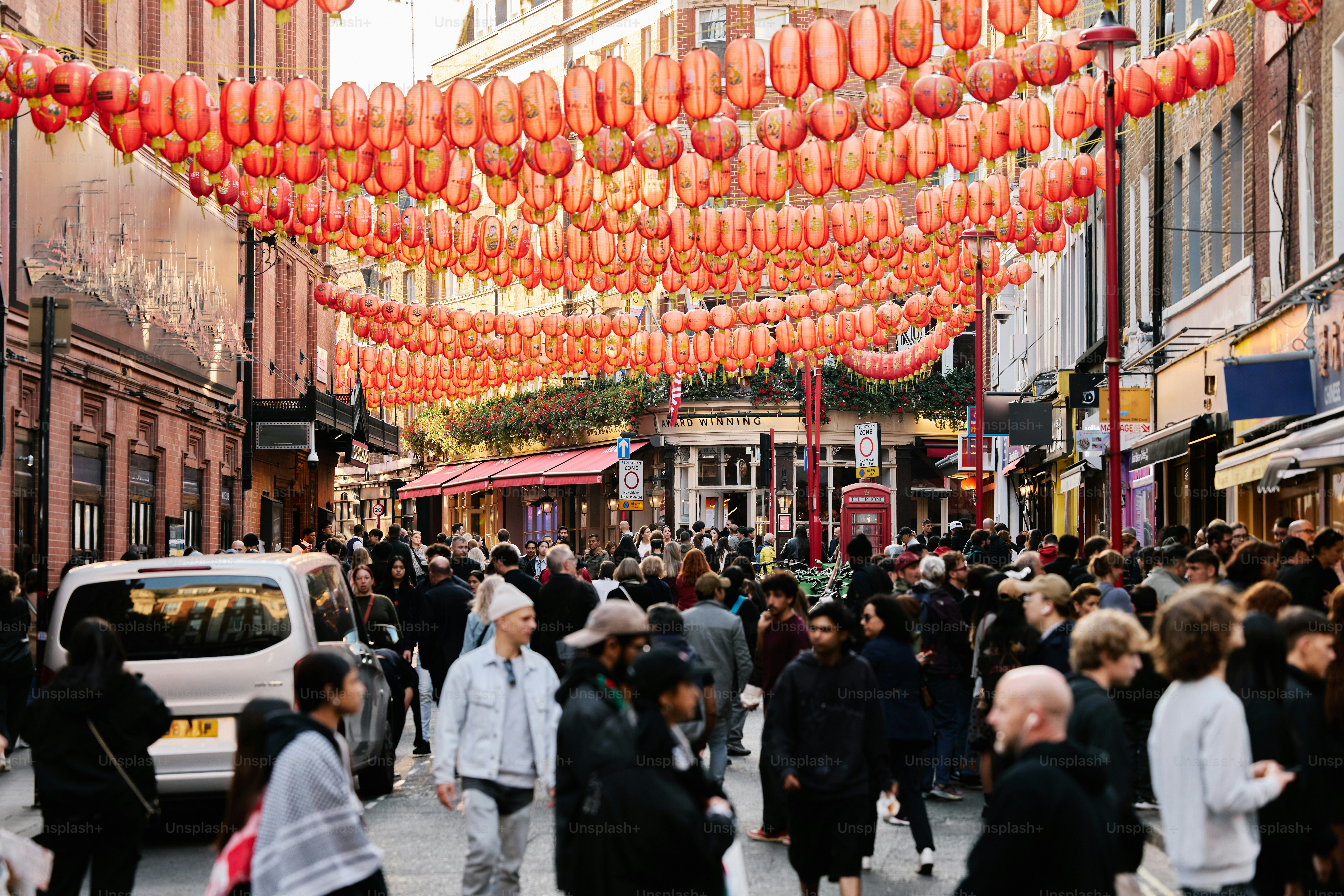 Crowded street decorated with many red lanterns