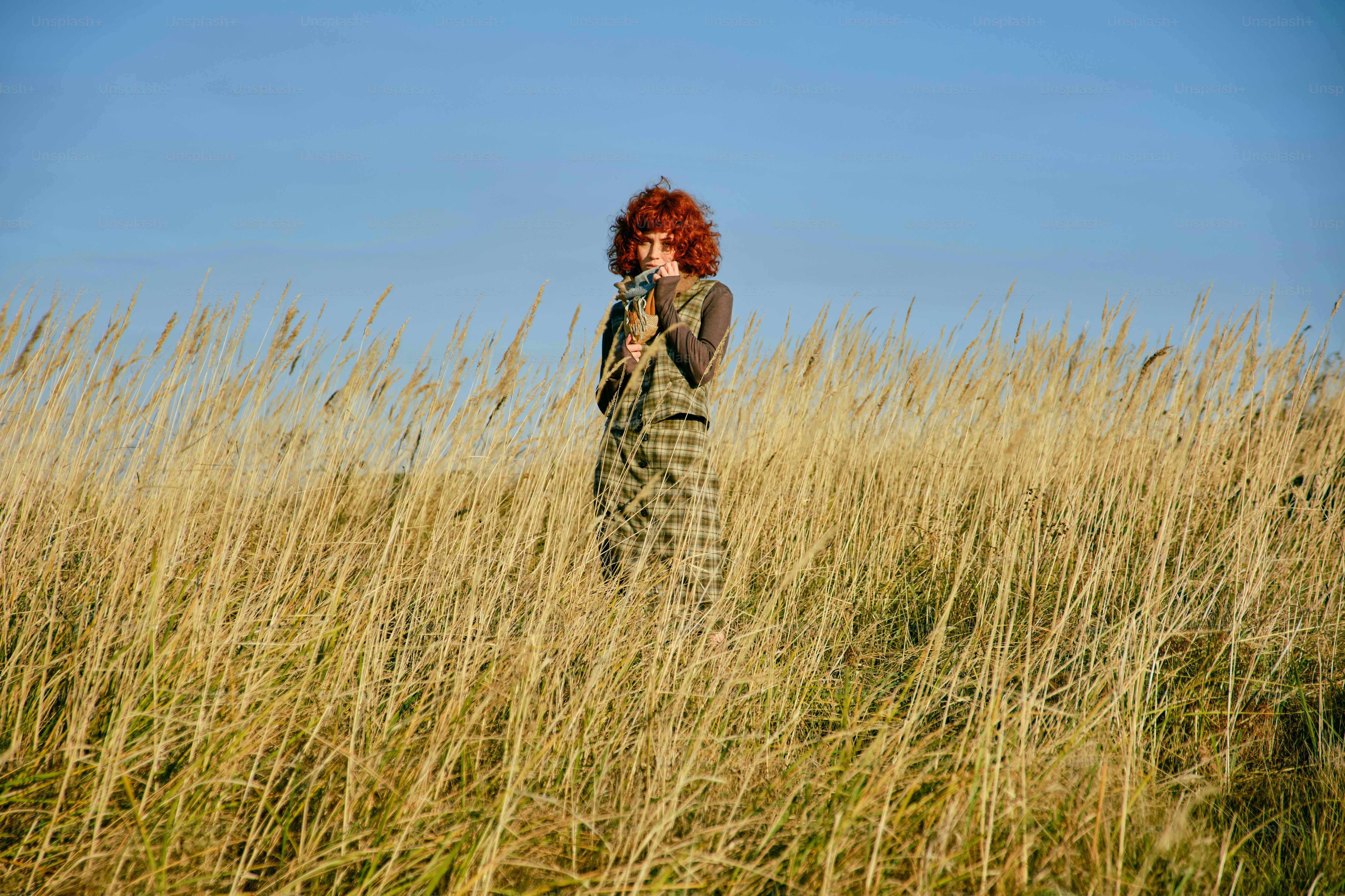 Woman with red hair in a field of tall grass photo – Model Image on ...