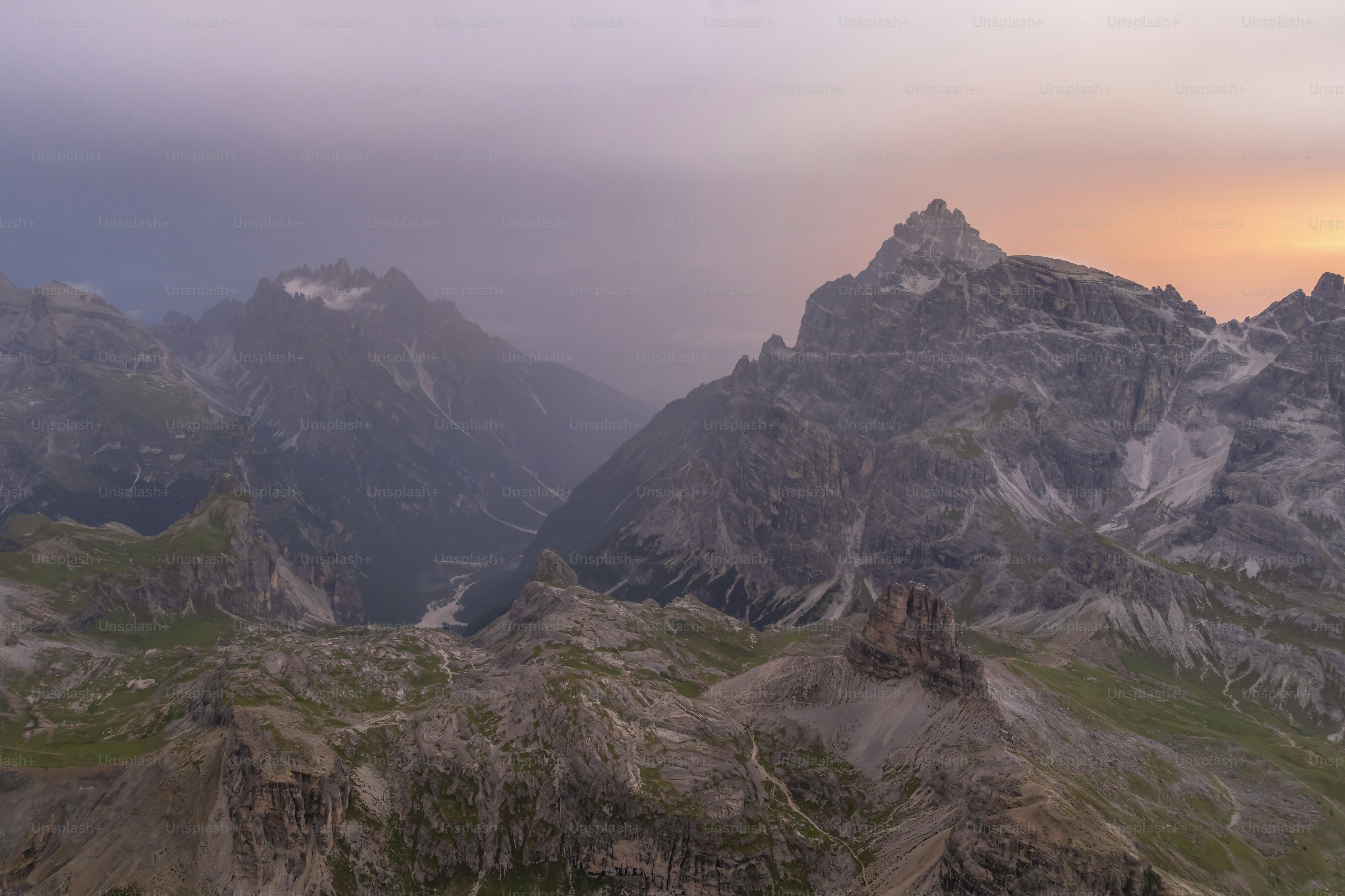 Majestic mountain peaks at sunset with soft pastel sky