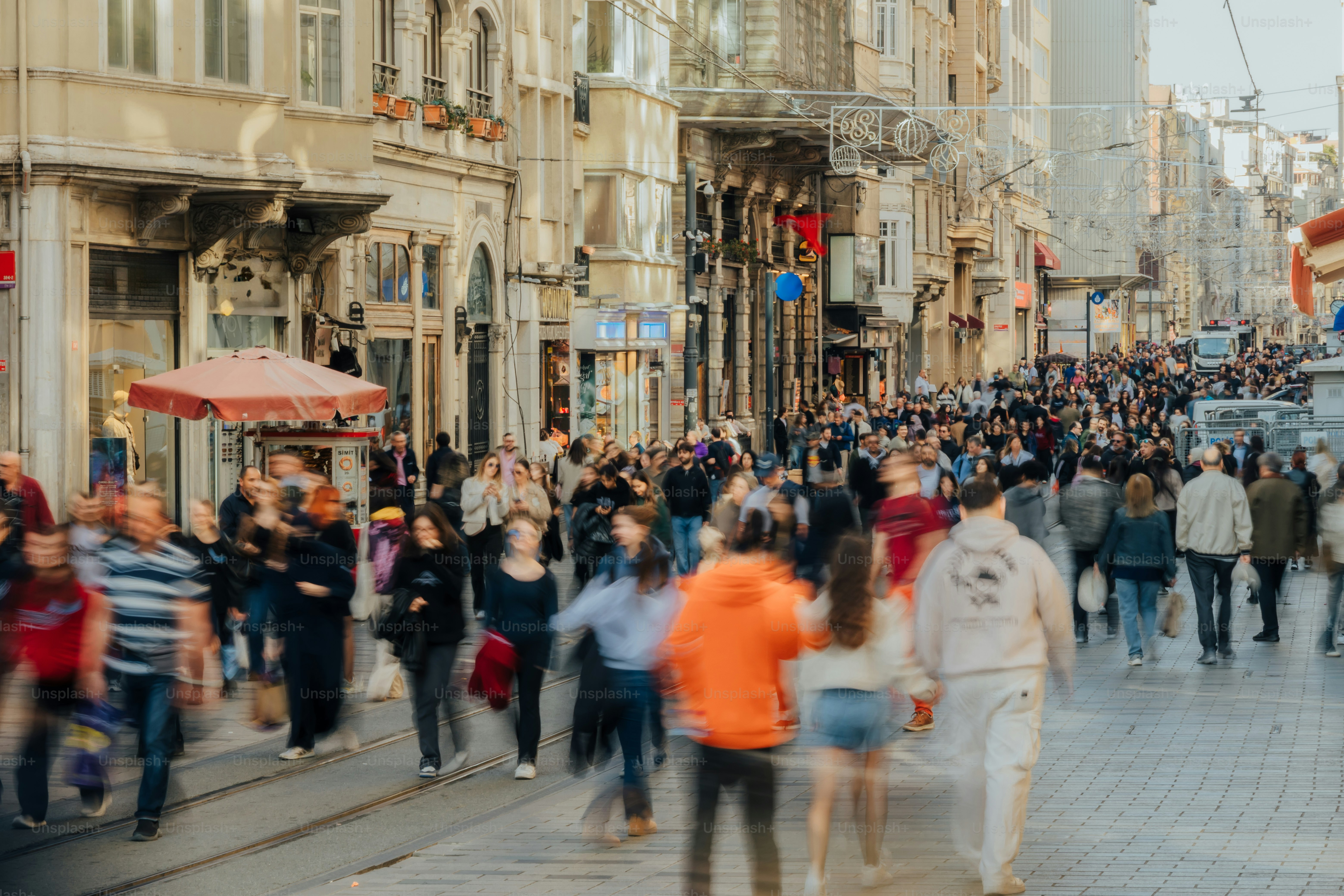 A bustling street scene with many people walking