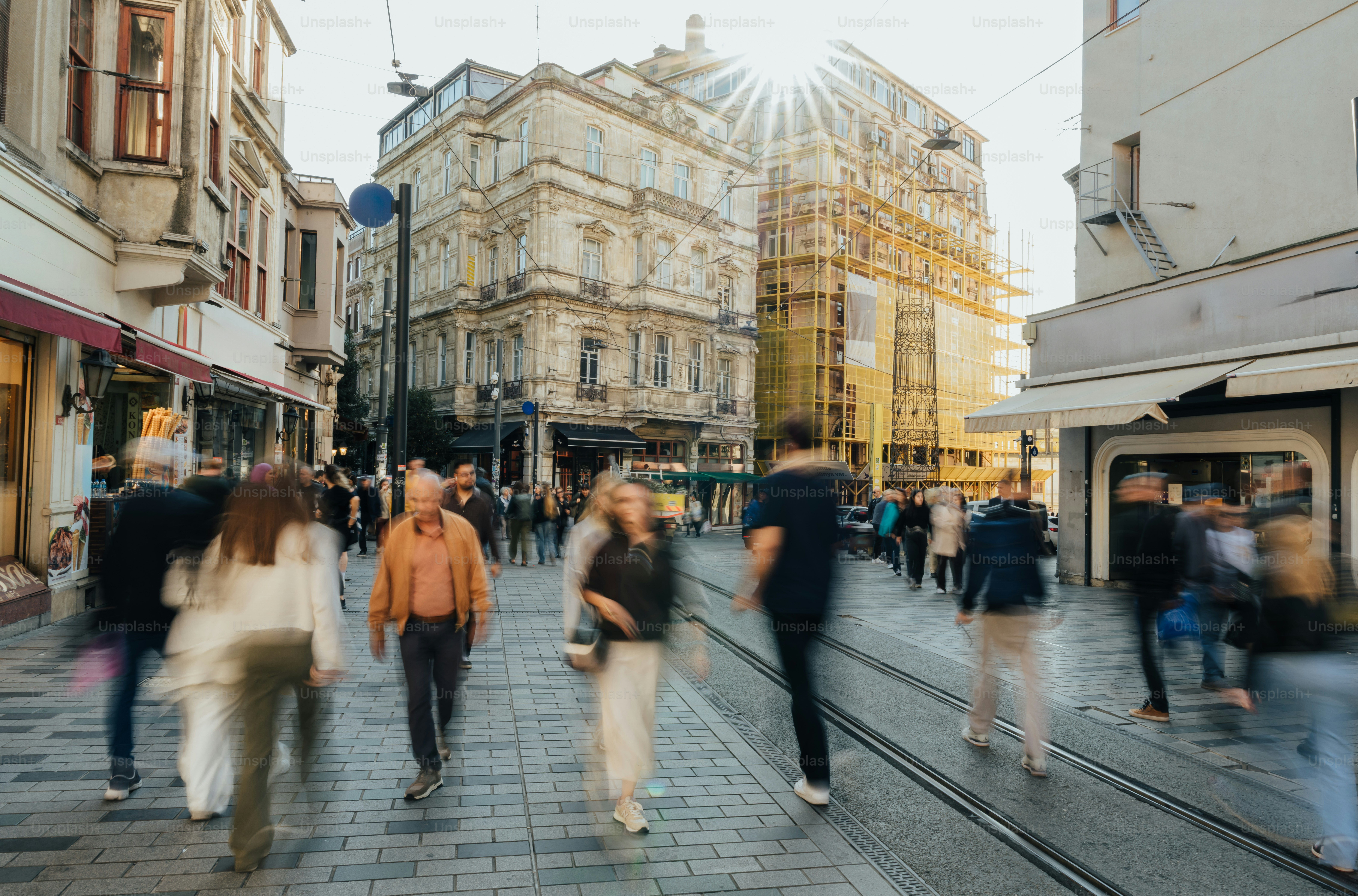 People walking on a bustling city street with buildings. photo ...