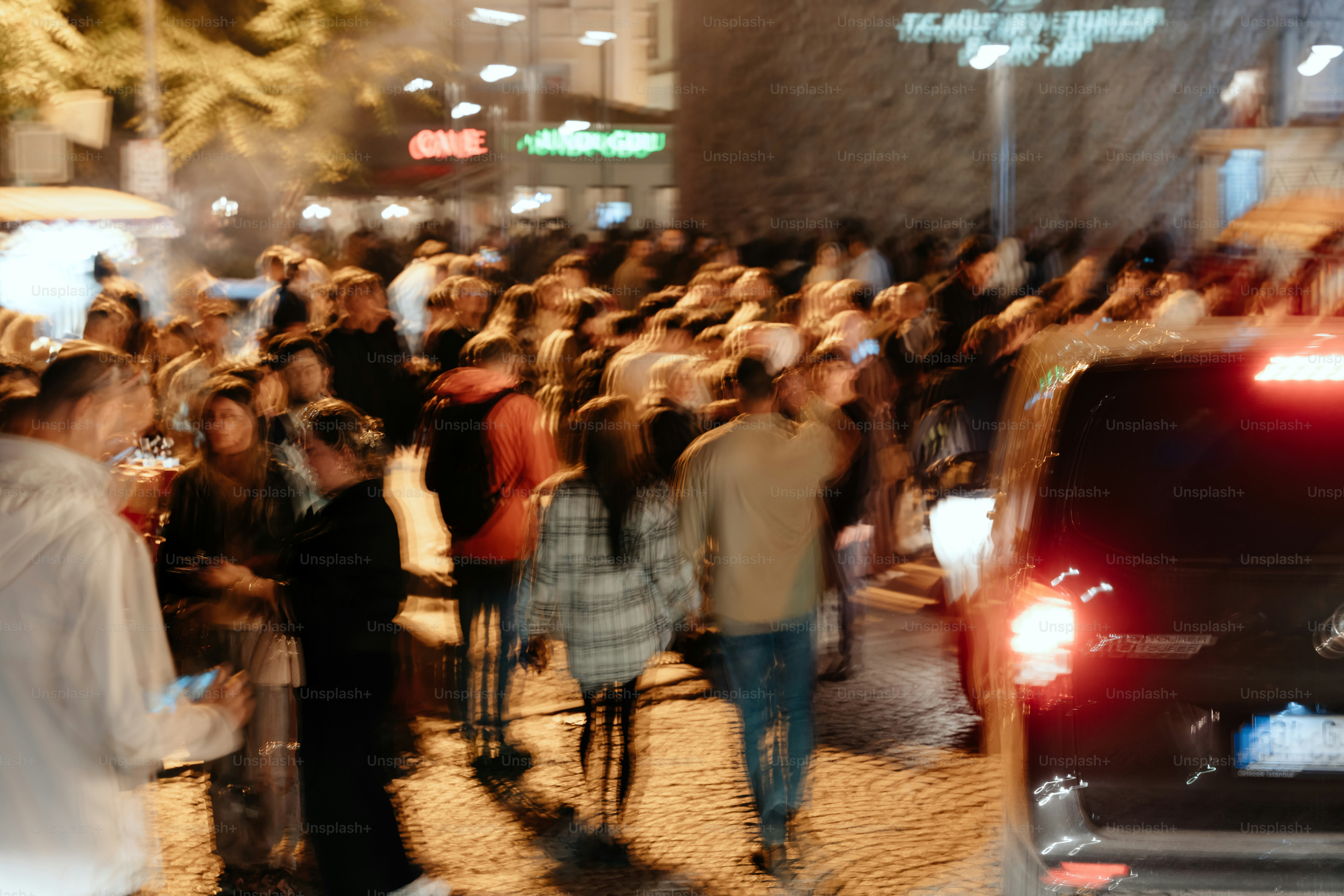 Crowd of people walking on a street at night