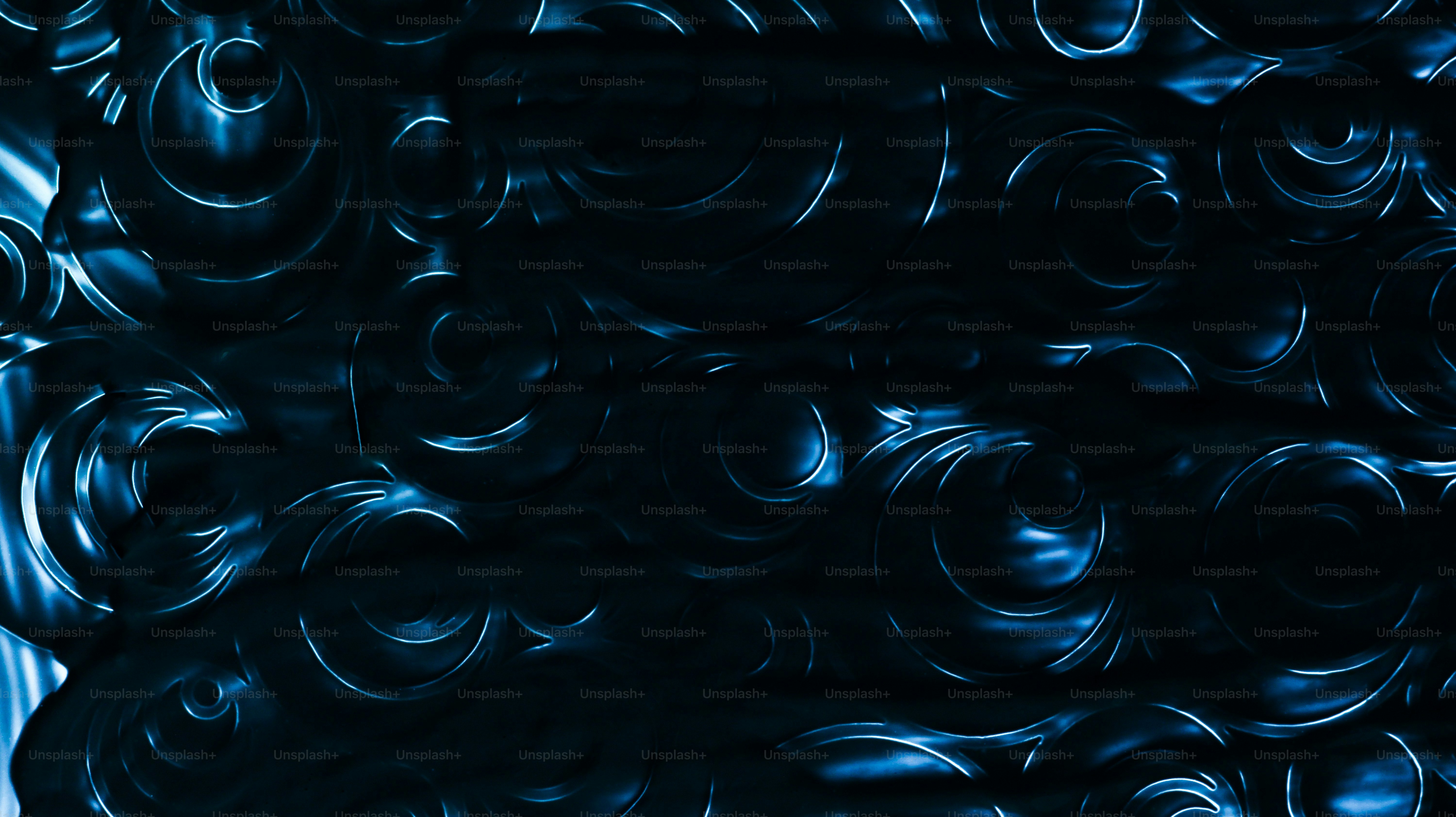Abstract dark blue swirling patterns with light highlights