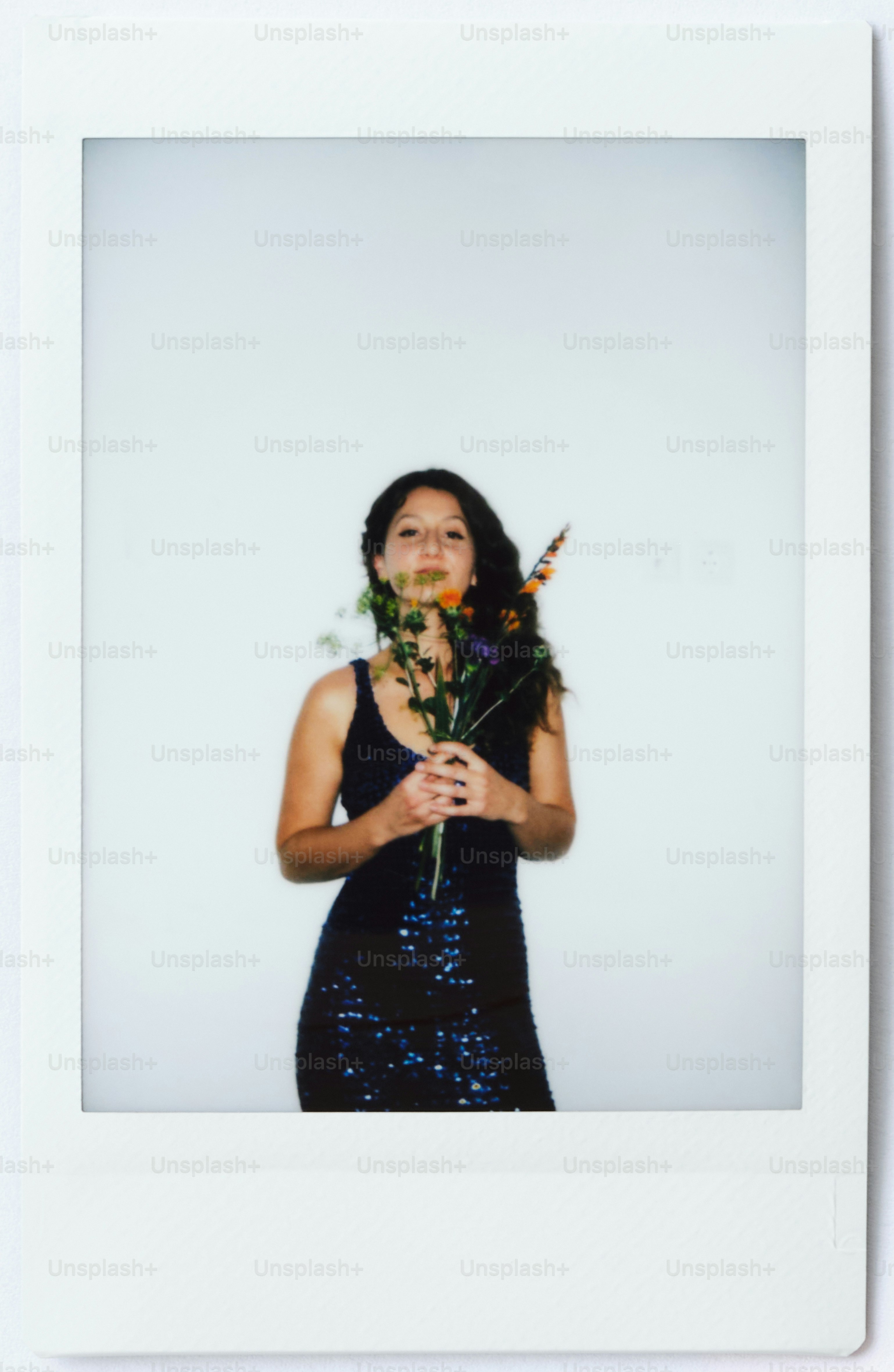 Woman in sparkly dress holding a bouquet of flowers