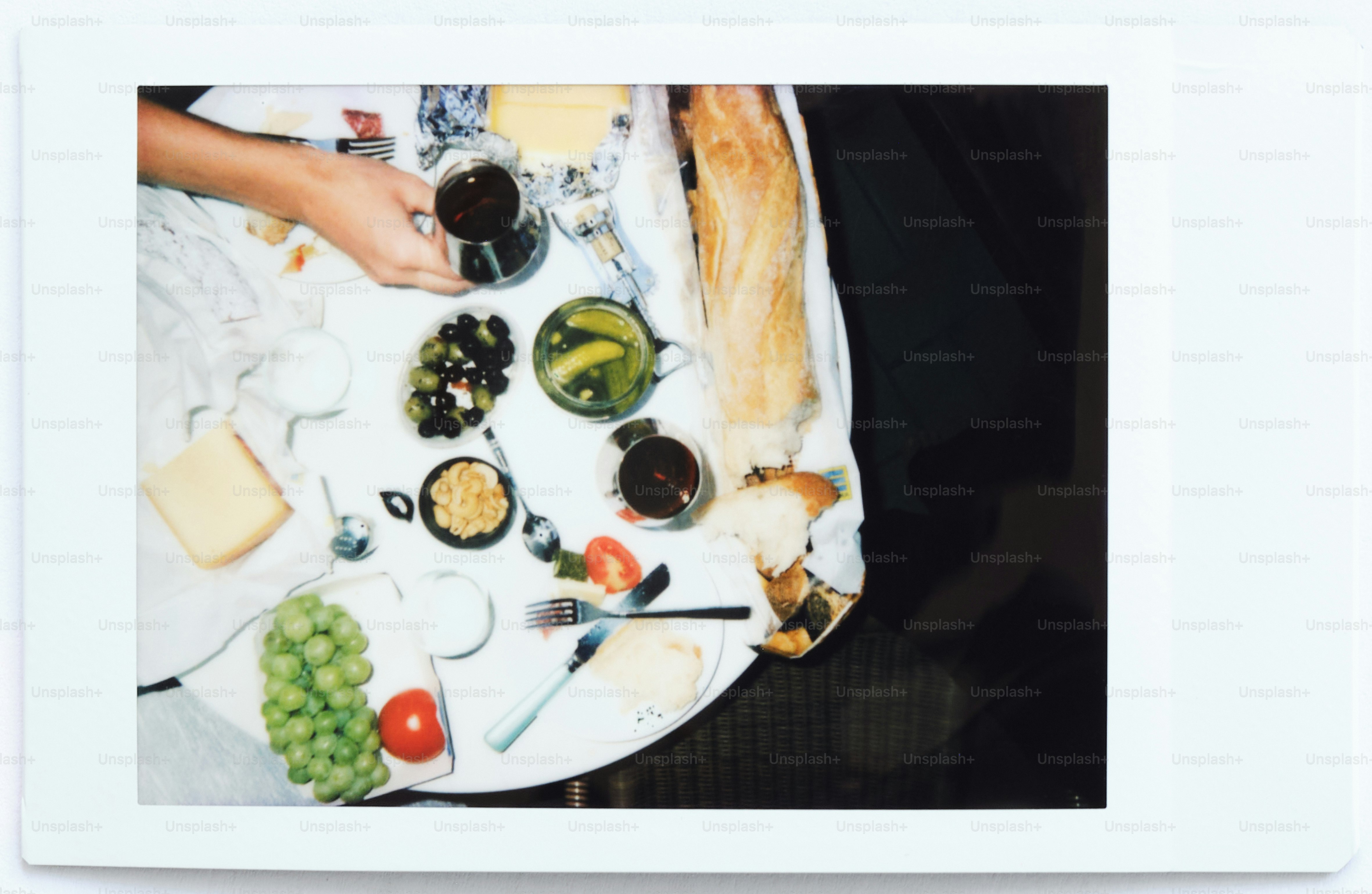 Messy table after a meal with plates and food. photo – Film photography ...