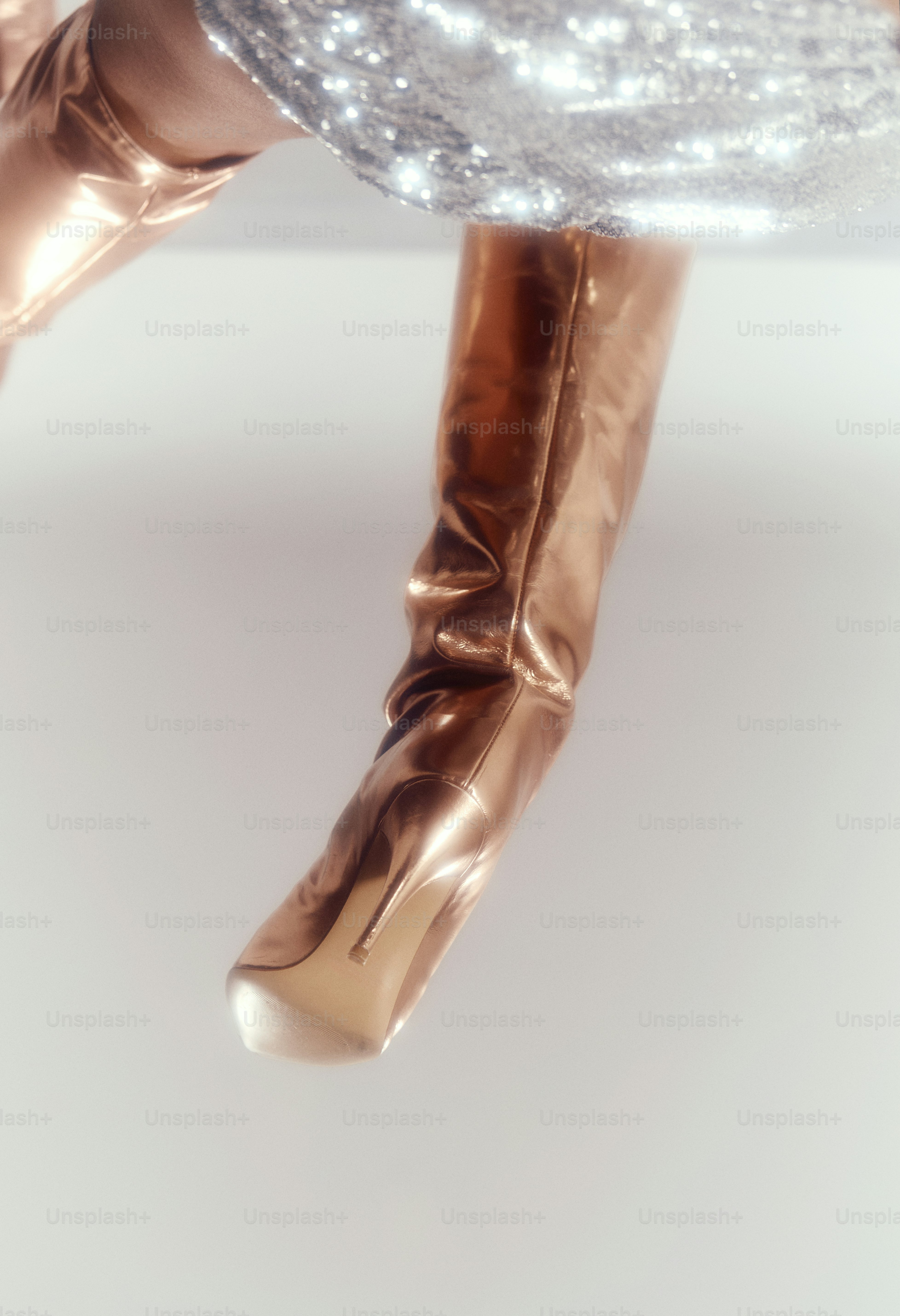 Woman wearing shiny copper boots and sequin skirt