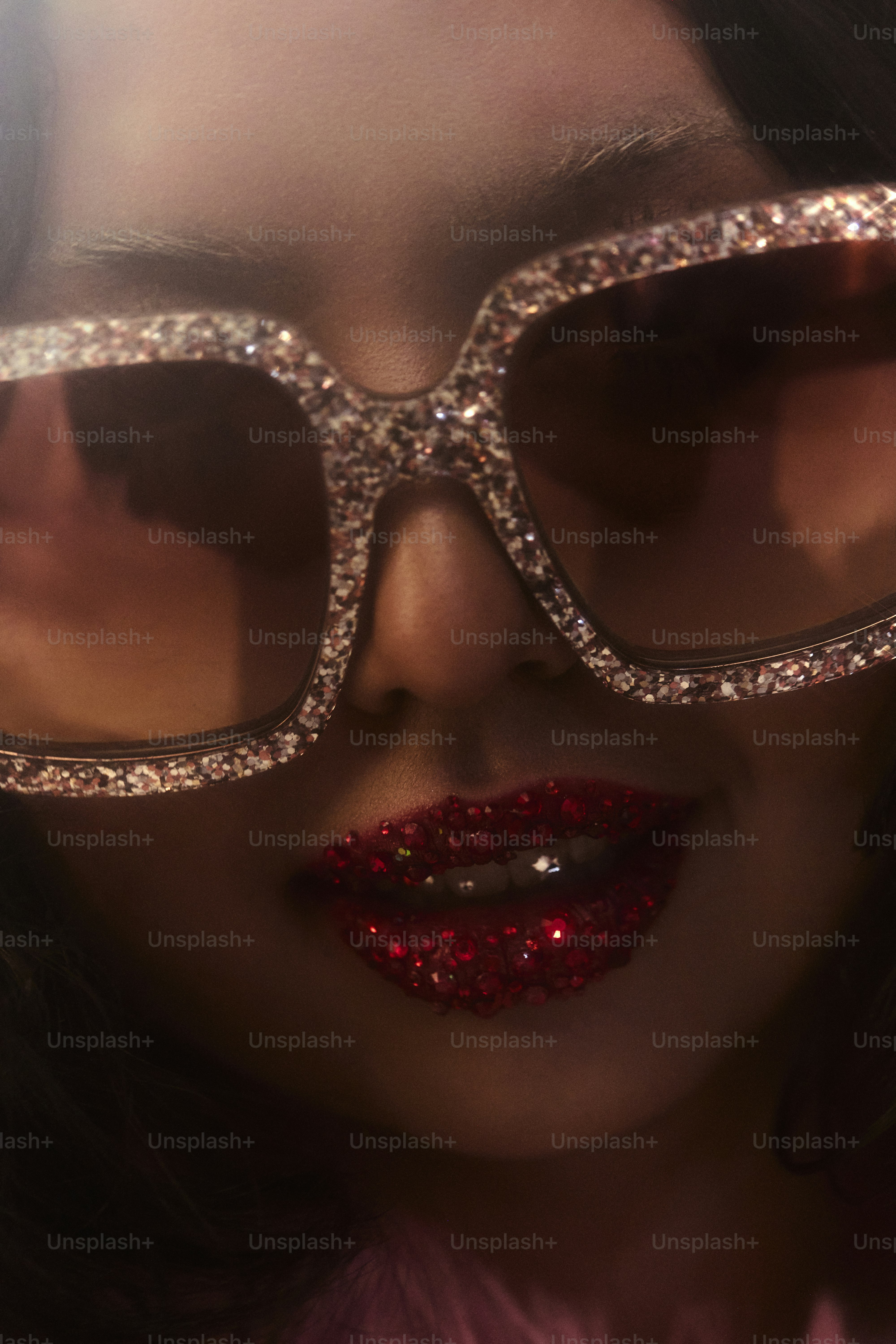 Woman with glittery red lips and sparkly sunglasses