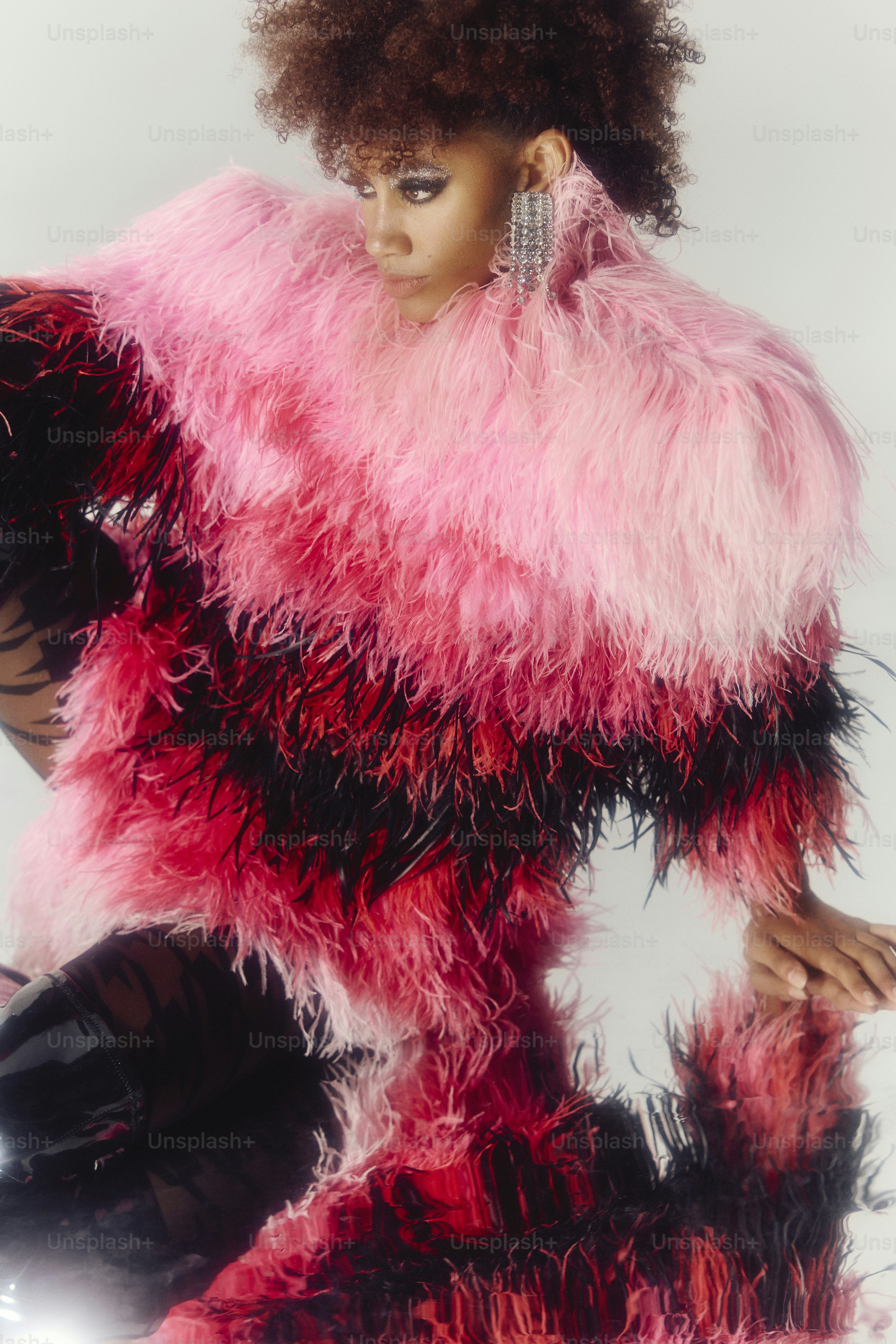 Woman in pink and black feathered coat