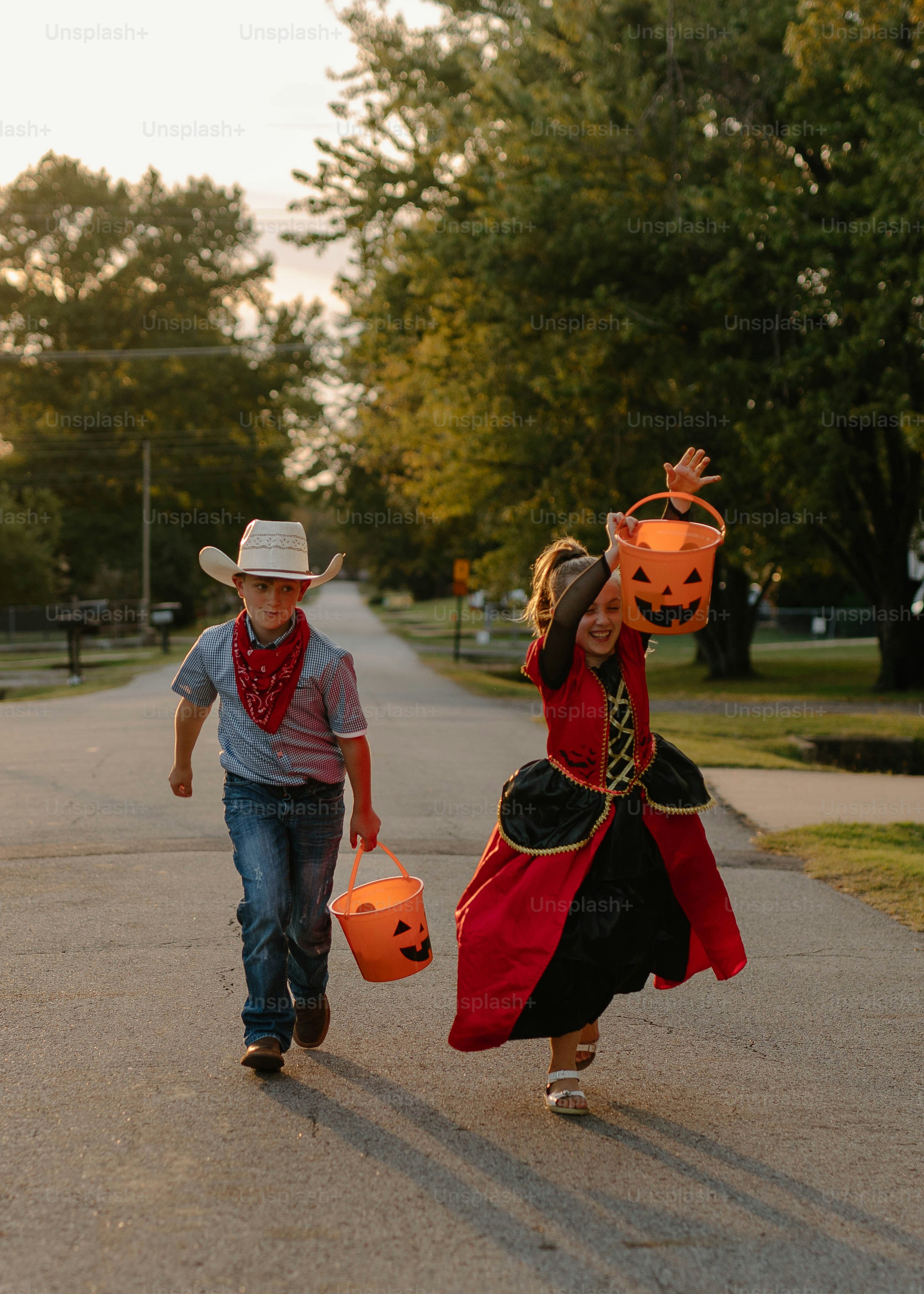 Children in halloween costumes trick-or-treating on street