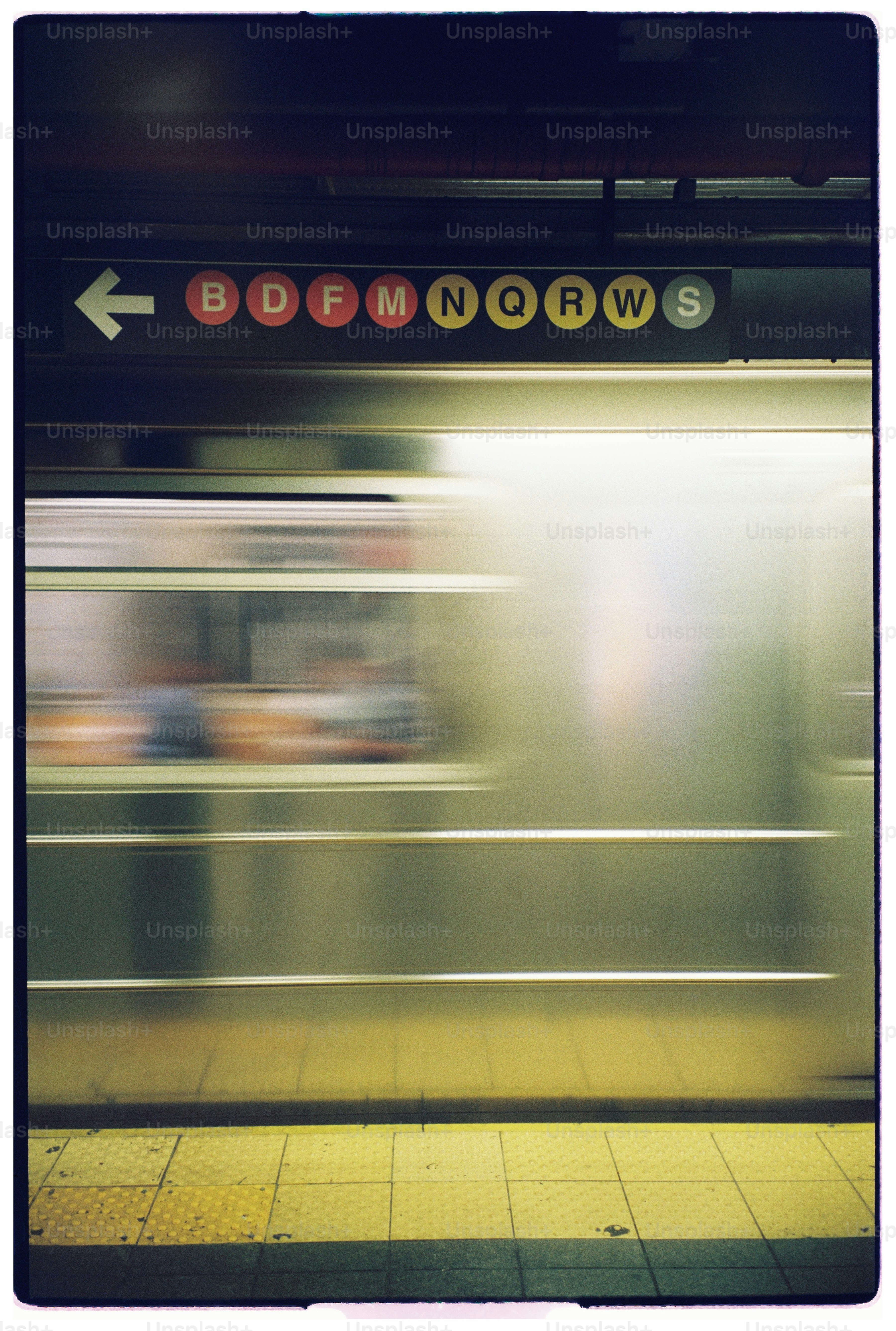 A train speeds past a subway platform.
